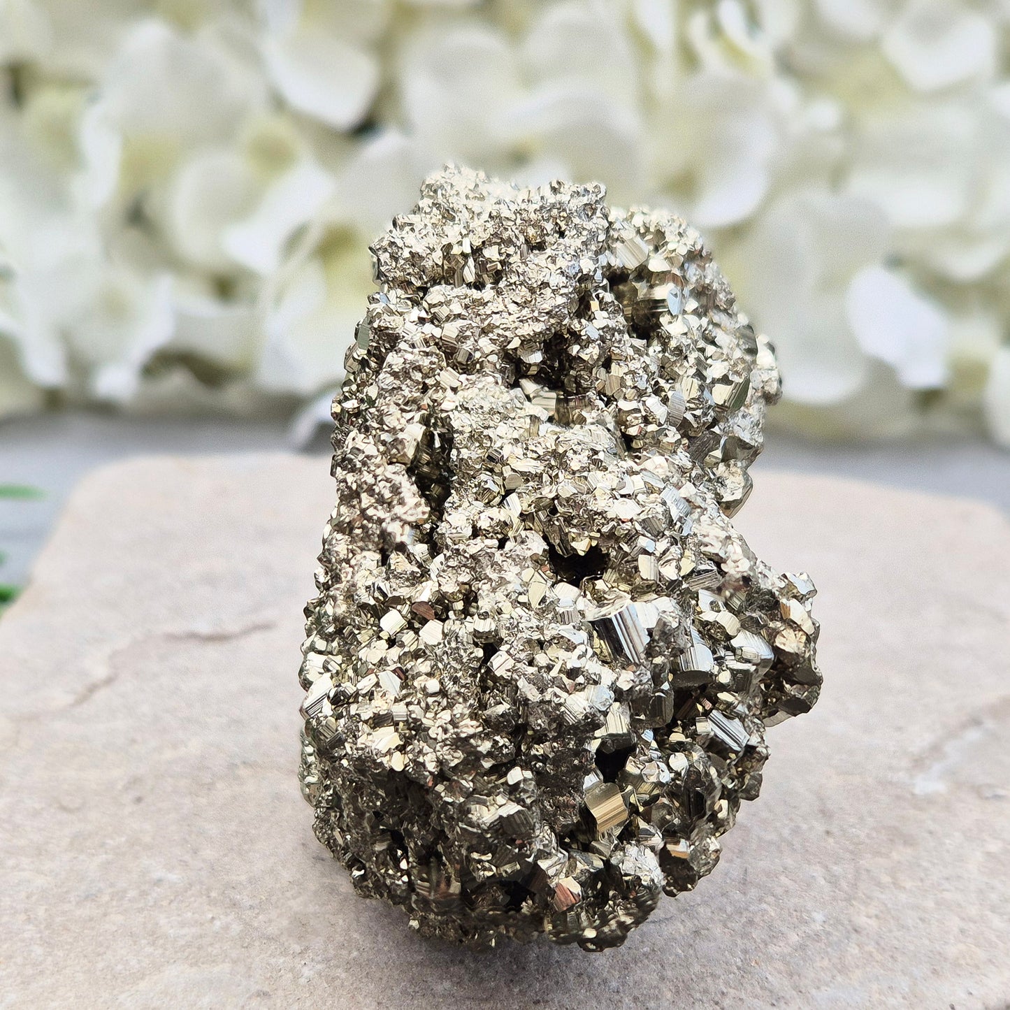 Natural pyrite crystal cluster from Peru featuring defined cubes & rich gold lustre. A striking, light-catching piece for home decor, desks, or crystal lovers.