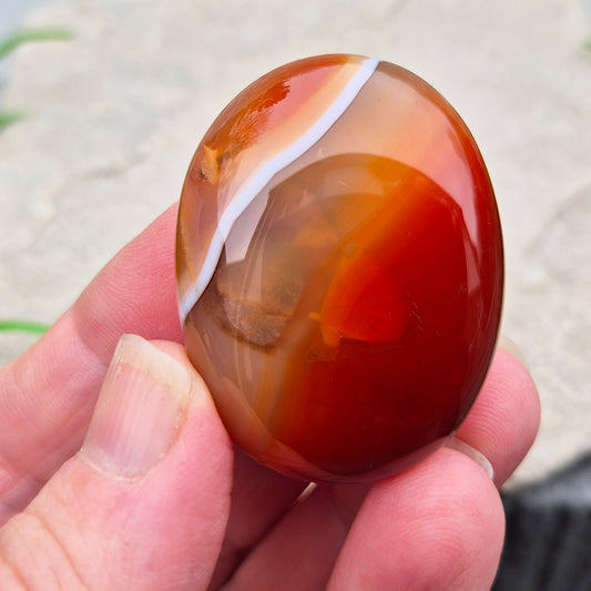Banded Carnelian palm stone from Madagascar. Boosts motivation, confidence and creativity. Grounding Root and Sacral crystal for energy and focus. 