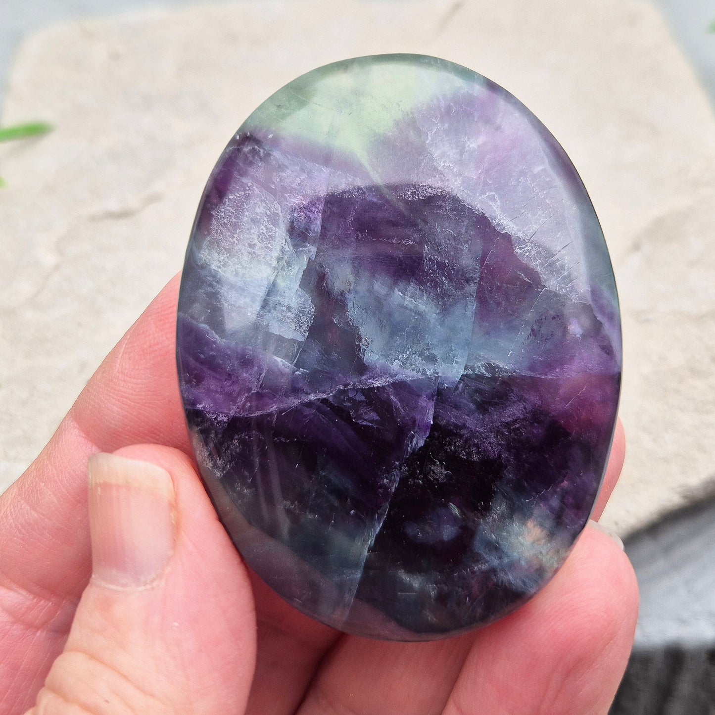 Rainbow Fluorite palm stone for focus and balance. Polished banded crystal to calm the mind, support clear thinking and ease overwhelm.