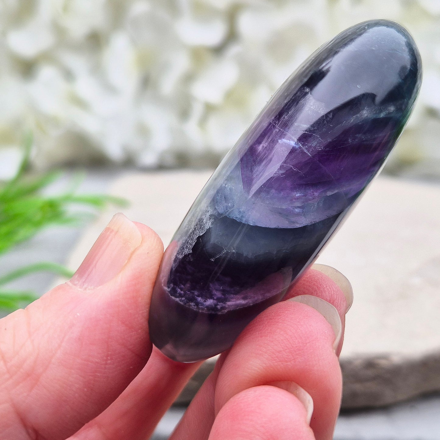 Rainbow Fluorite palm stone for focus and balance. Polished banded crystal to calm the mind, support clear thinking and ease overwhelm.
