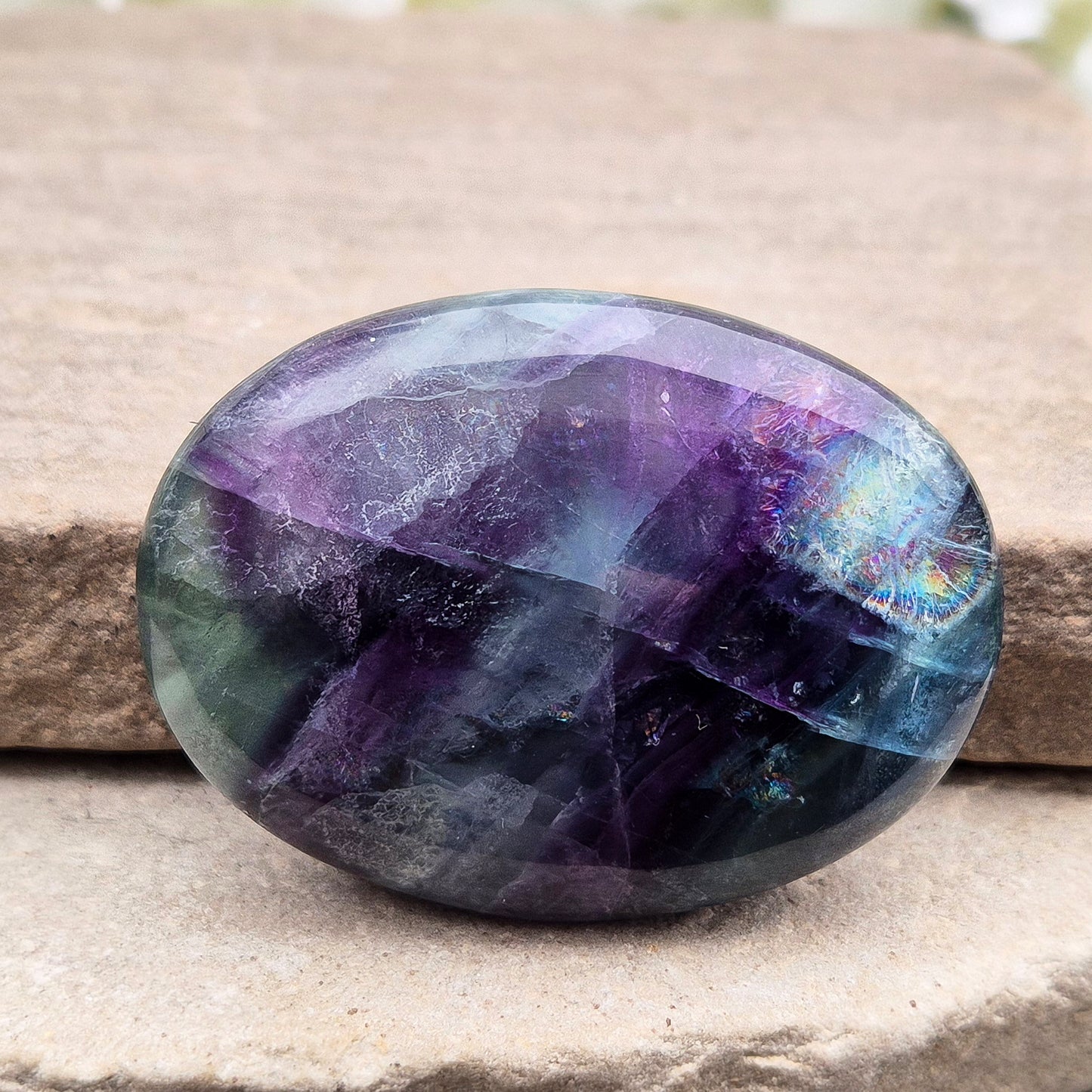 Rainbow Fluorite palm stone for focus and balance. Polished banded crystal to calm the mind, support clear thinking and ease overwhelm.