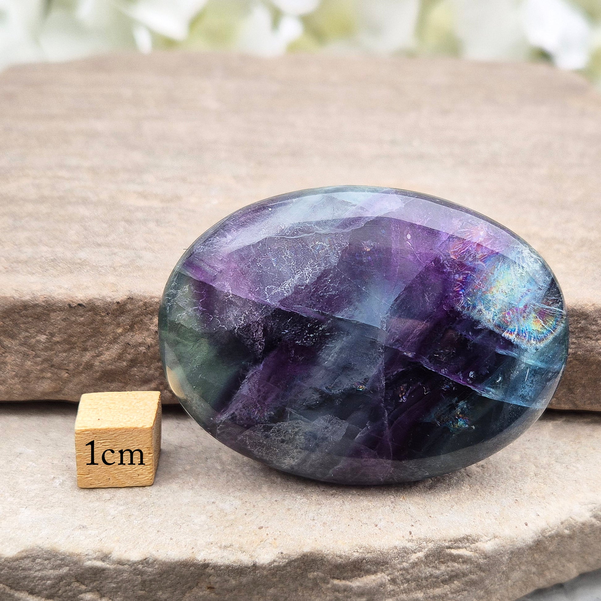 Rainbow Fluorite palm stone for focus and balance. Polished banded crystal to calm the mind, support clear thinking and ease overwhelm.