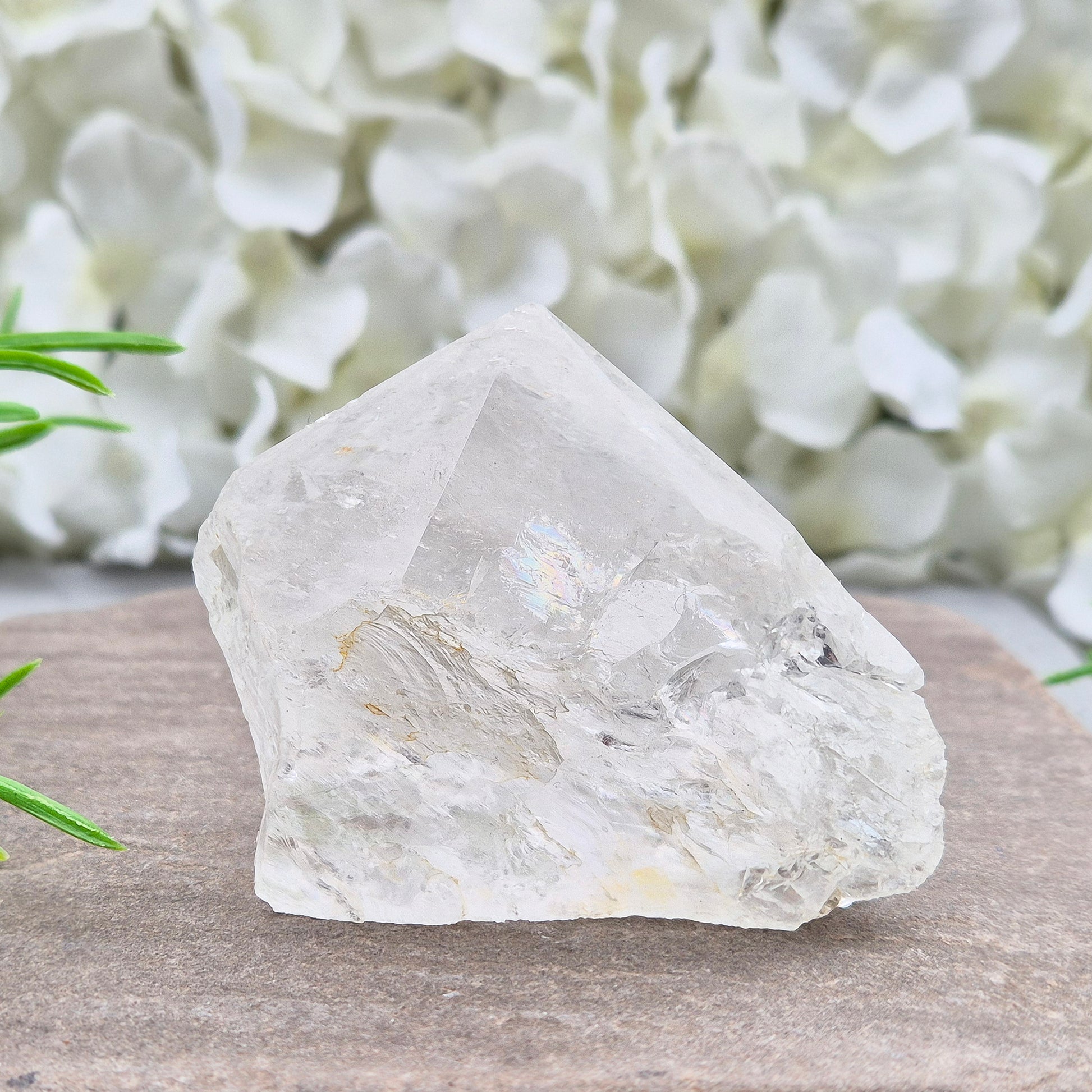 Quartz Crystal Standing Point. Point is polished at tip with a rainbow, sides are natural and the base is cut flat so it will sit on an even surface.
