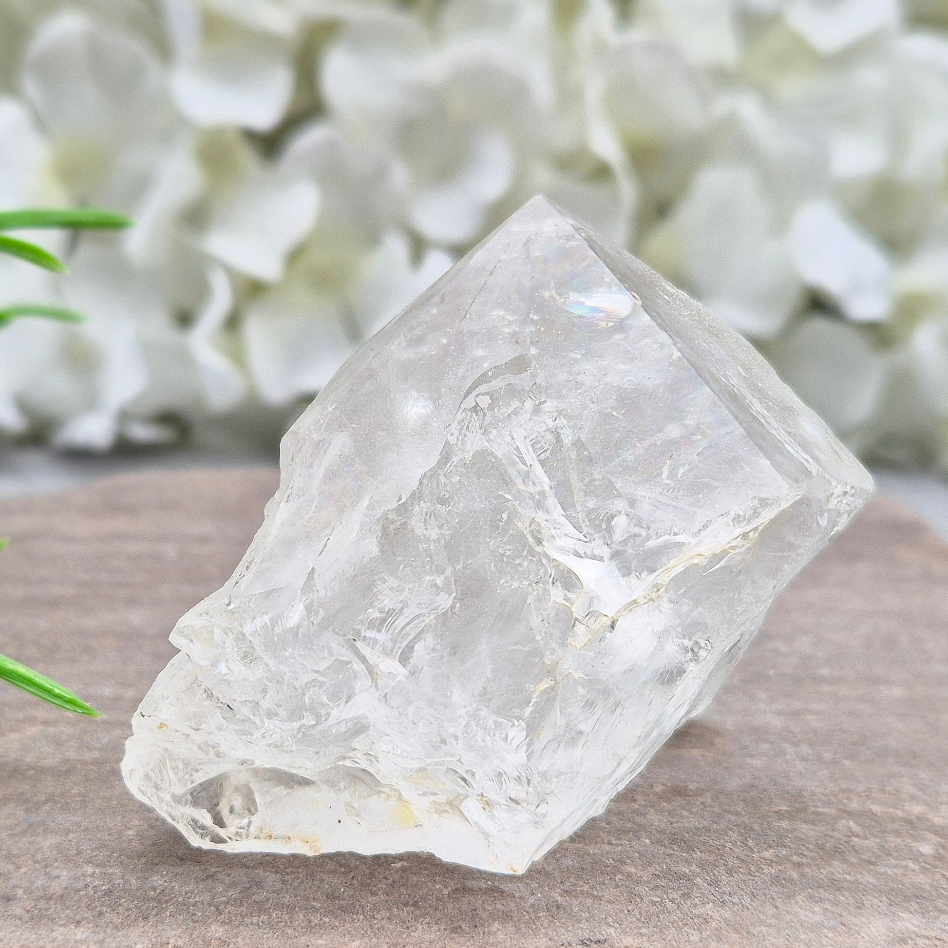 Quartz Crystal Standing Point. Point is polished at tip with a rainbow, sides are natural and the base is cut flat so it will sit on an even surface.