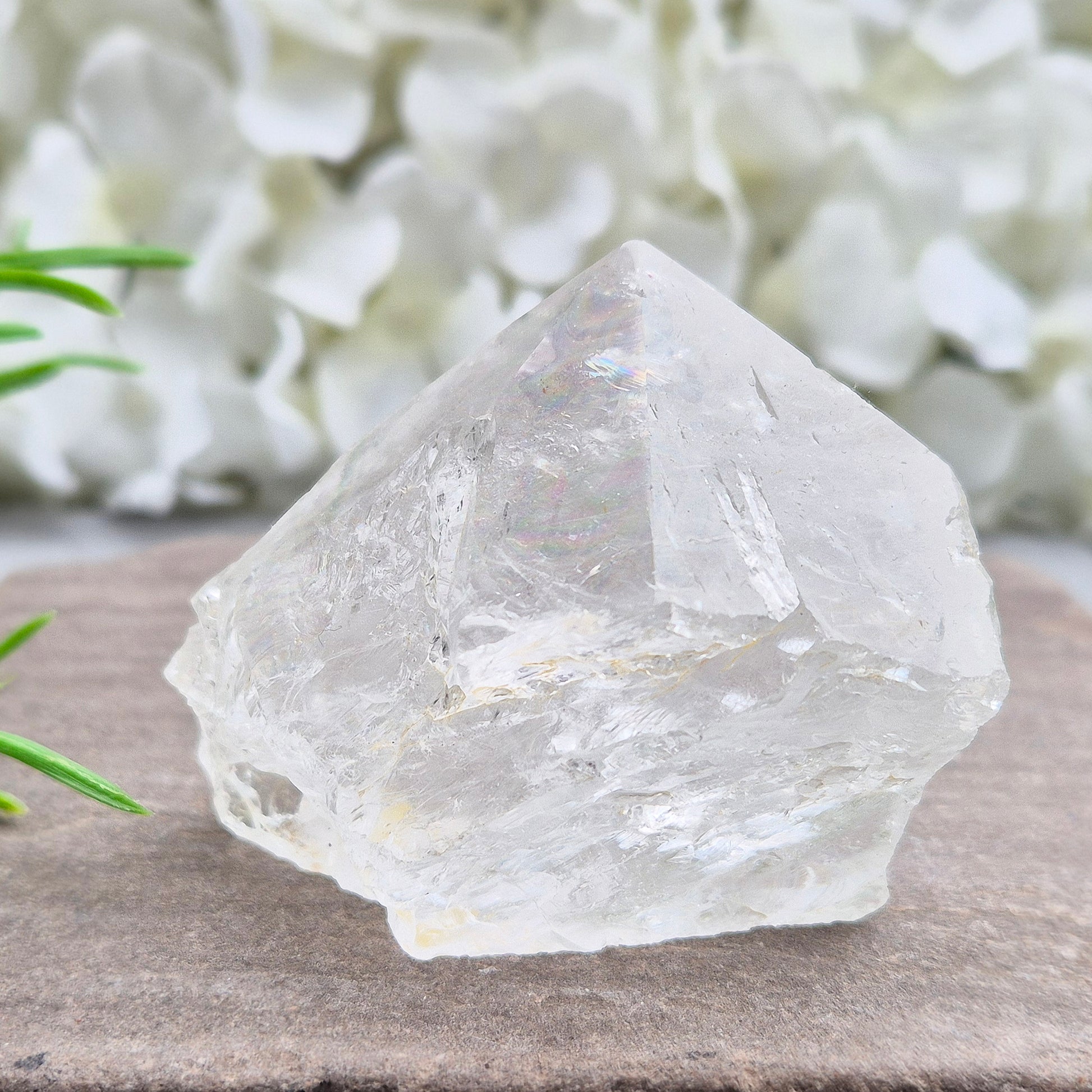 Quartz Crystal Standing Point. Point is polished at tip with a rainbow, sides are natural and the base is cut flat so it will sit on an even surface.