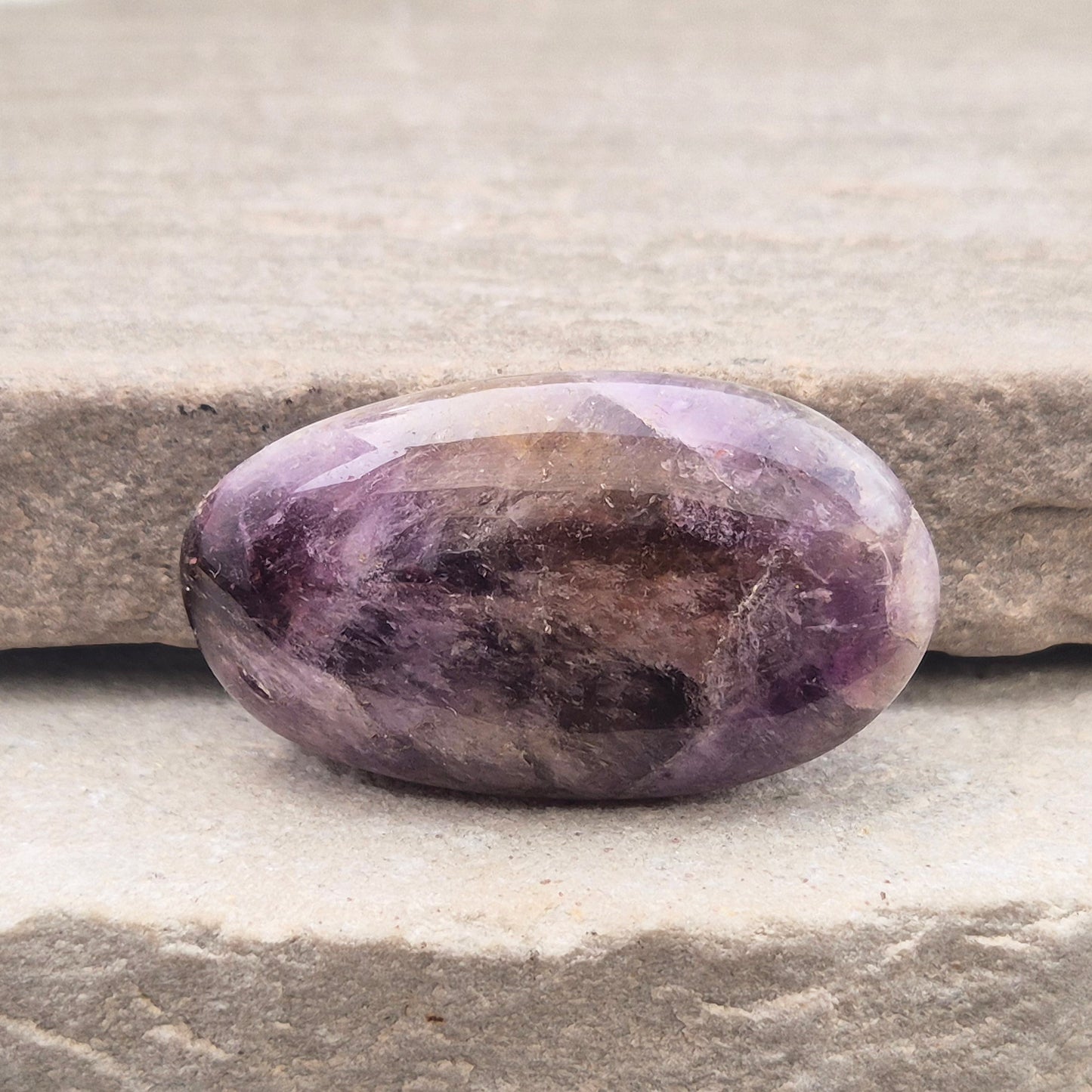 Ametrine polished palm stone with soft purple and golden tones. A natural blend of Amethyst and Citrine with a balanced, easy feel.