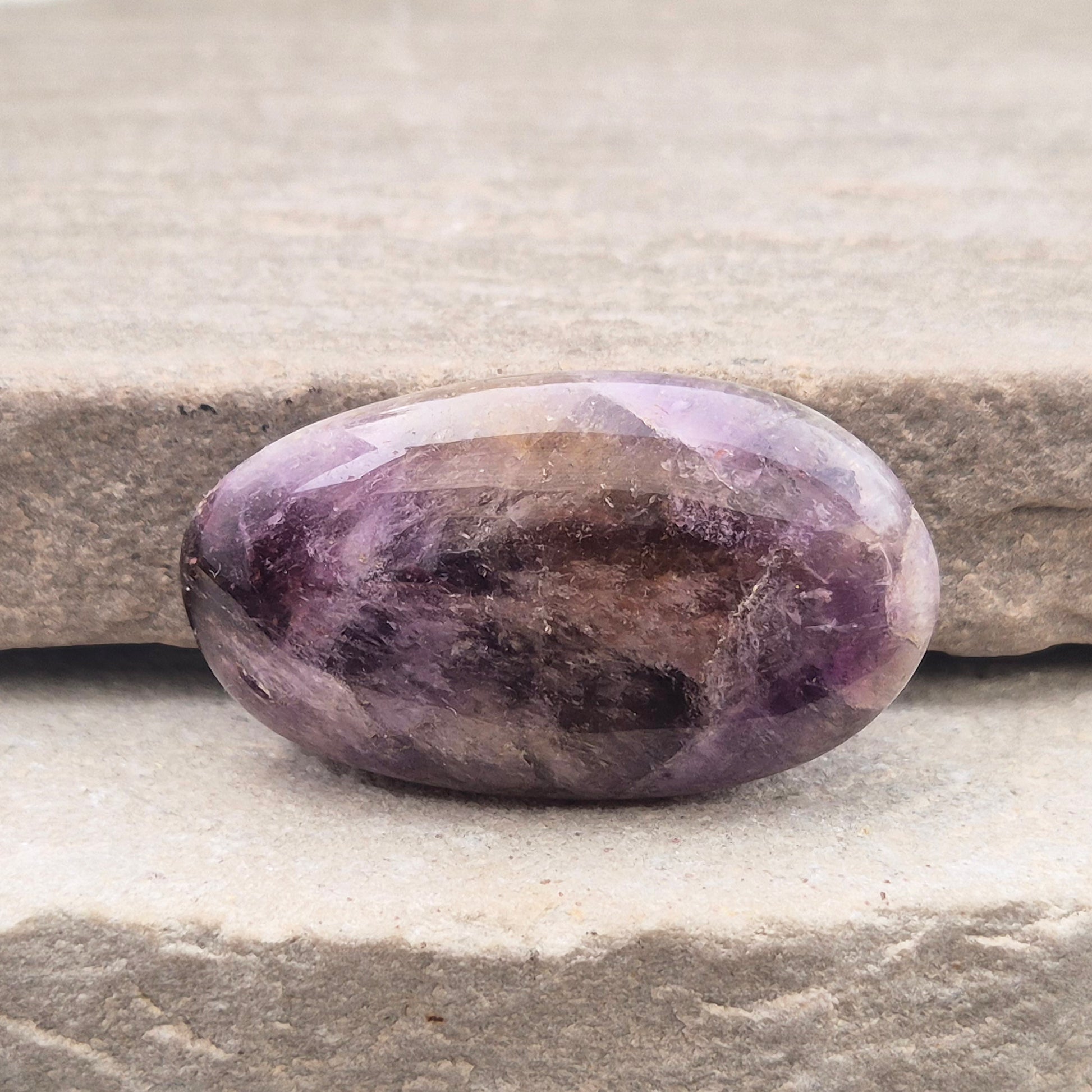 Ametrine polished palm stone with soft purple and golden tones. A natural blend of Amethyst and Citrine with a balanced, easy feel.