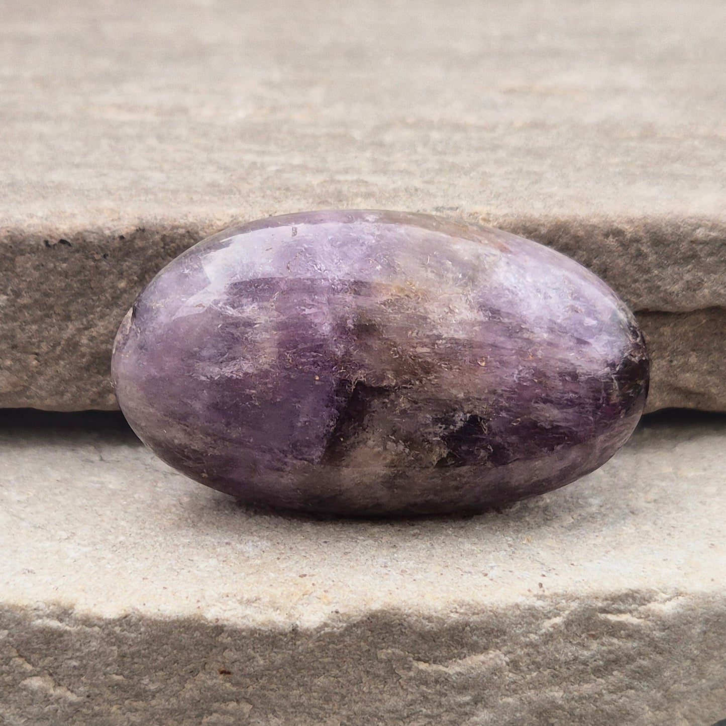 Ametrine polished palm stone with soft purple and golden tones. A natural blend of Amethyst and Citrine with a balanced, easy feel.