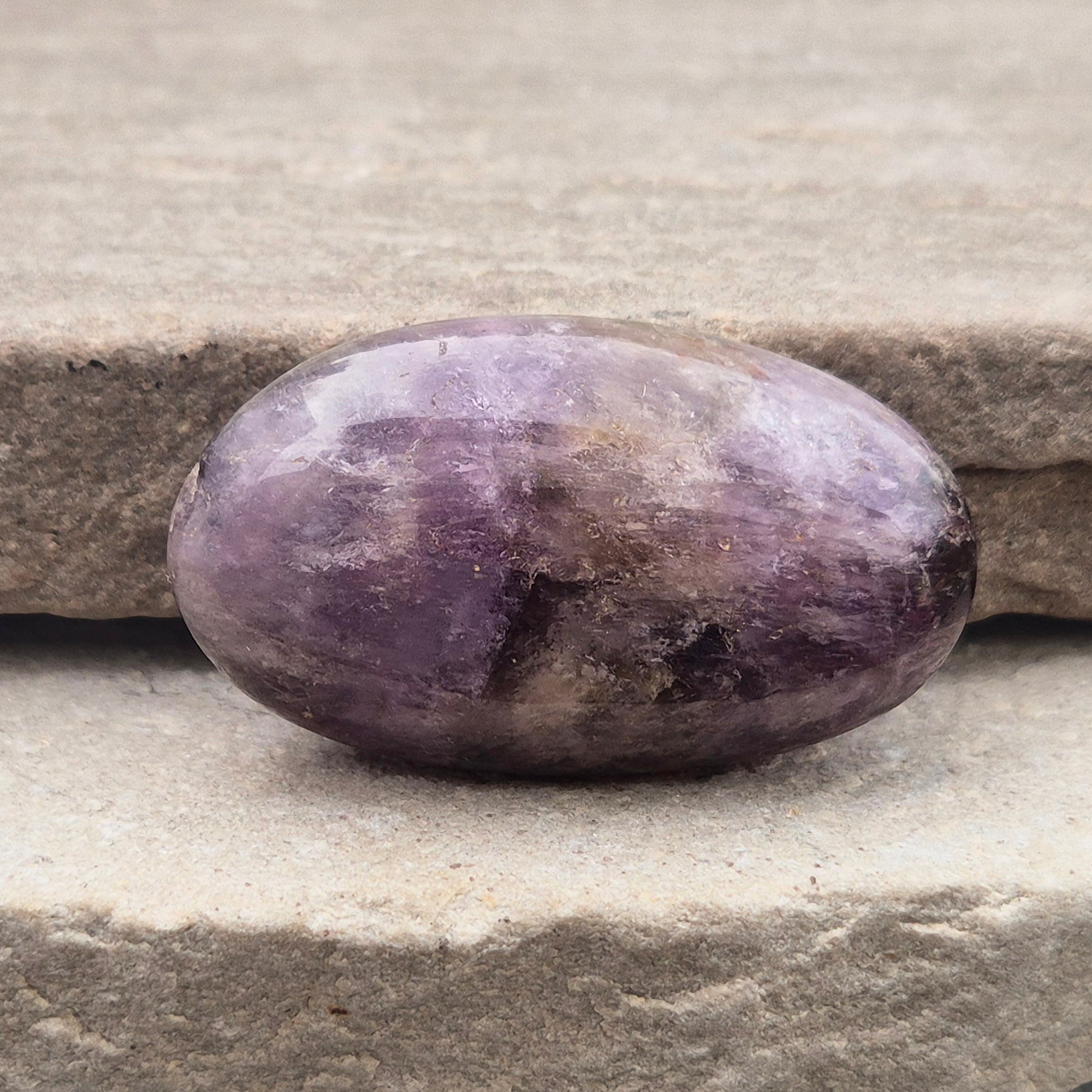 Ametrine polished palm stone with soft purple and golden tones. A natural blend of Amethyst and Citrine with a balanced, easy feel.