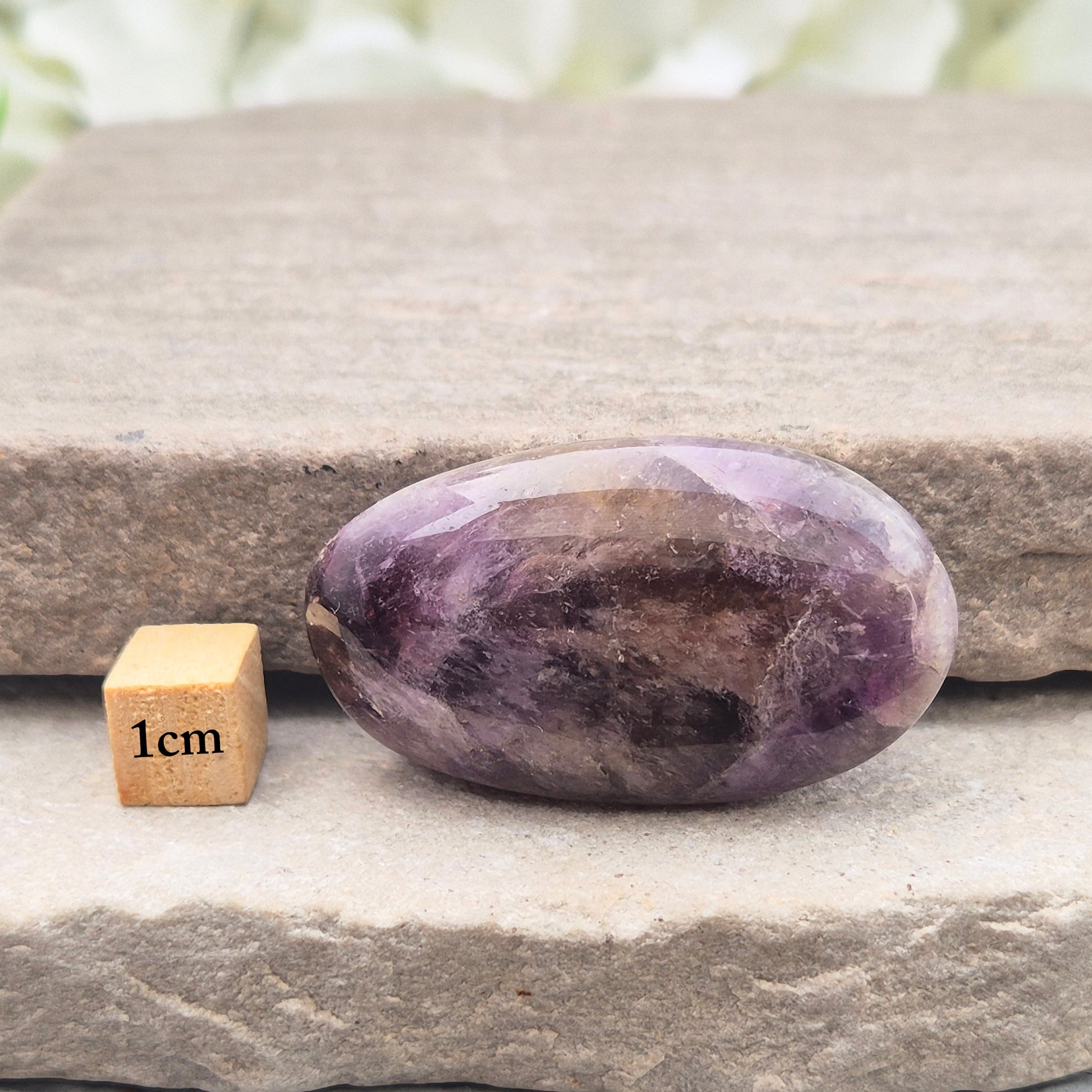 Ametrine polished palm stone with soft purple and golden tones. A natural blend of Amethyst and Citrine with a balanced, easy feel.