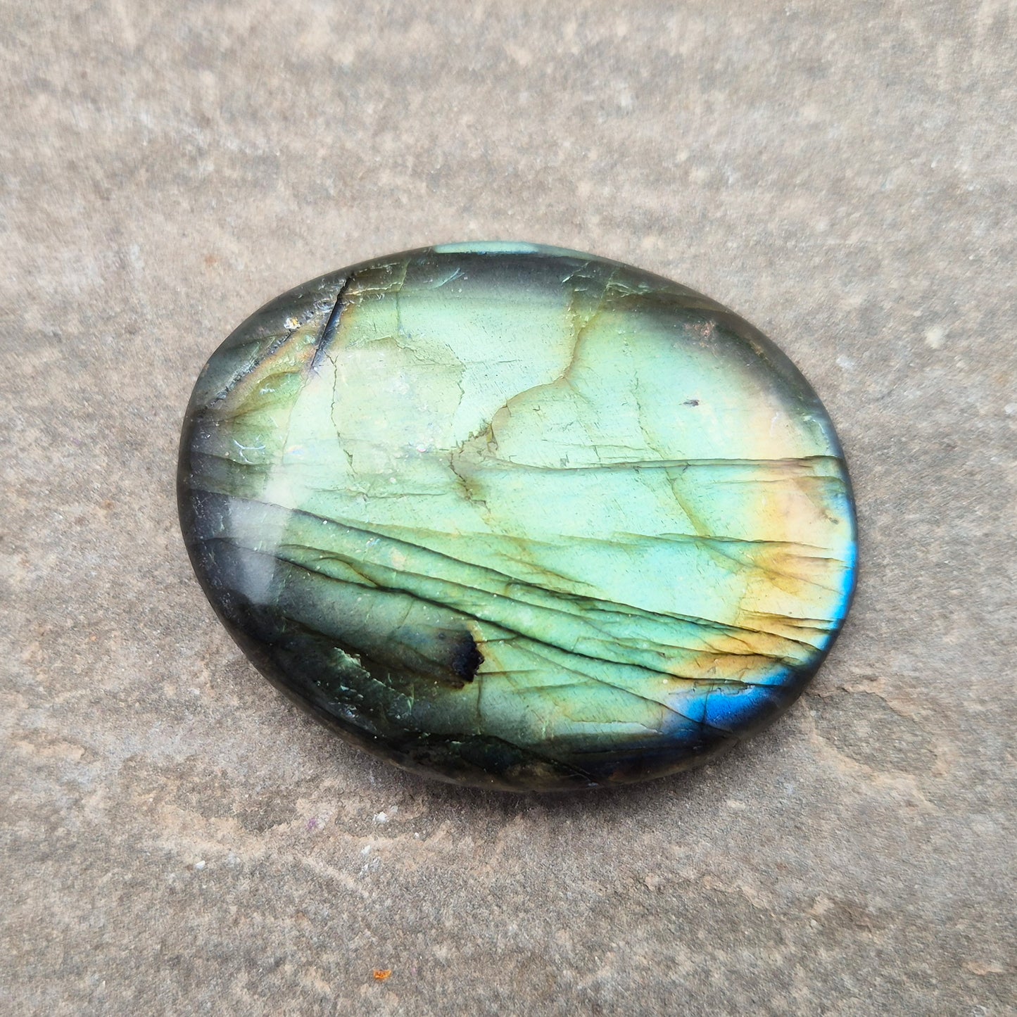 Labradorite palm stone with natural flash. Known for protection and intuition, helping shift energy and focus. Smooth, grounding, and easy to hold.