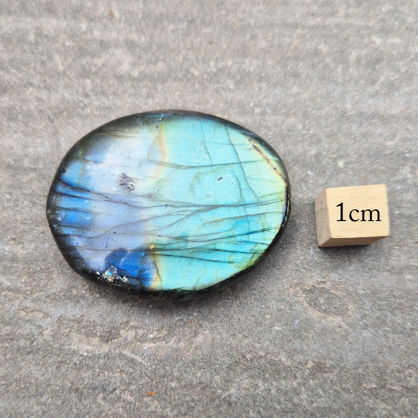 Labradorite palm stone with natural flash. Known for protection and intuition, helping shift energy and focus. Smooth, grounding, and easy to hold.