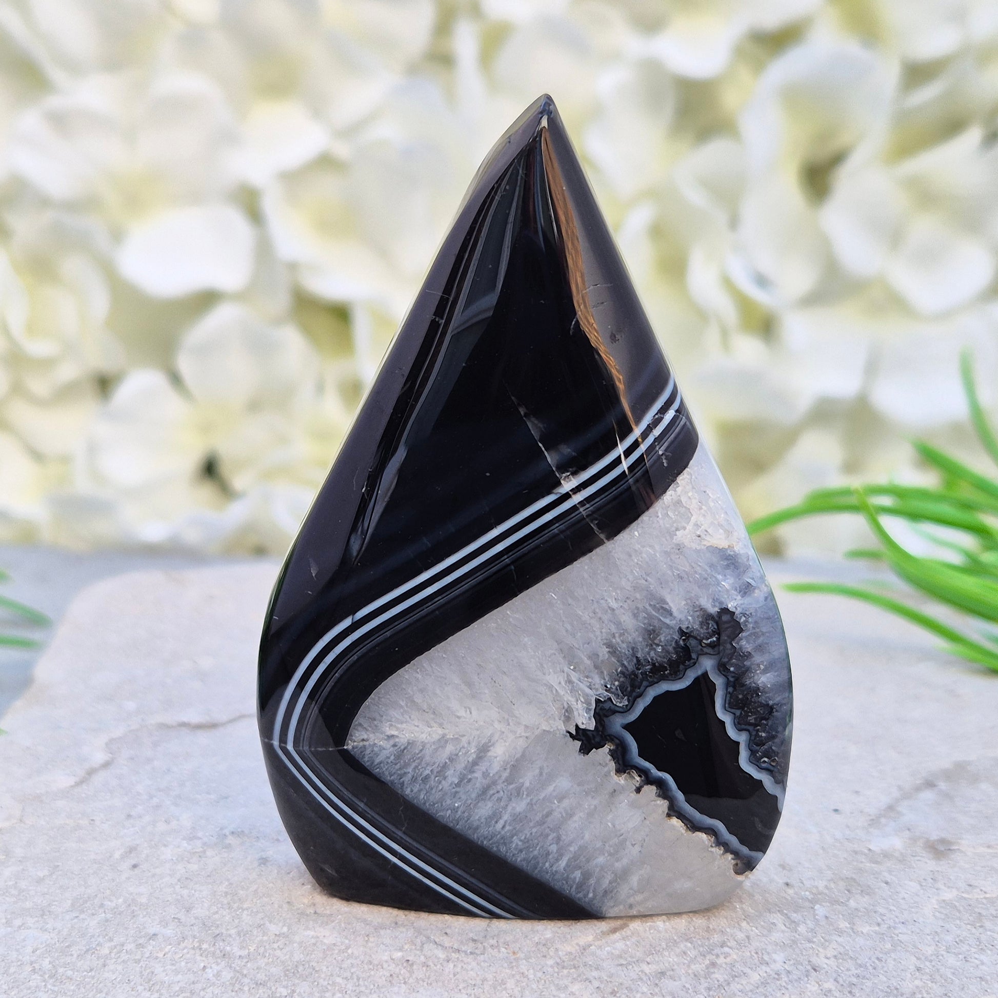 Polished black agate and quartz crystal flame from Brazil, traditionally associated with grounding and balance. A striking natural stone.