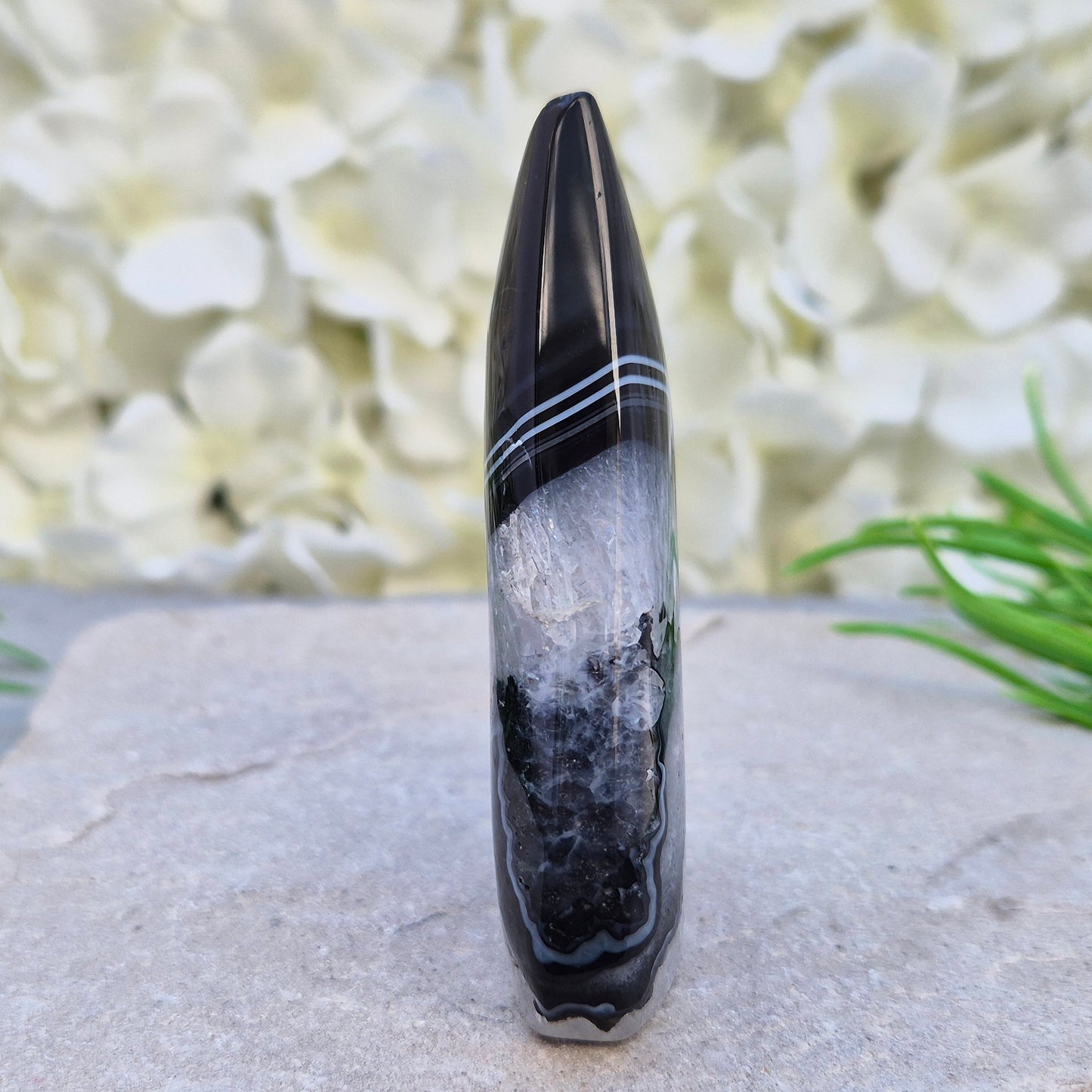 Polished black agate and quartz crystal flame from Brazil, traditionally associated with grounding and balance. A striking natural stone.