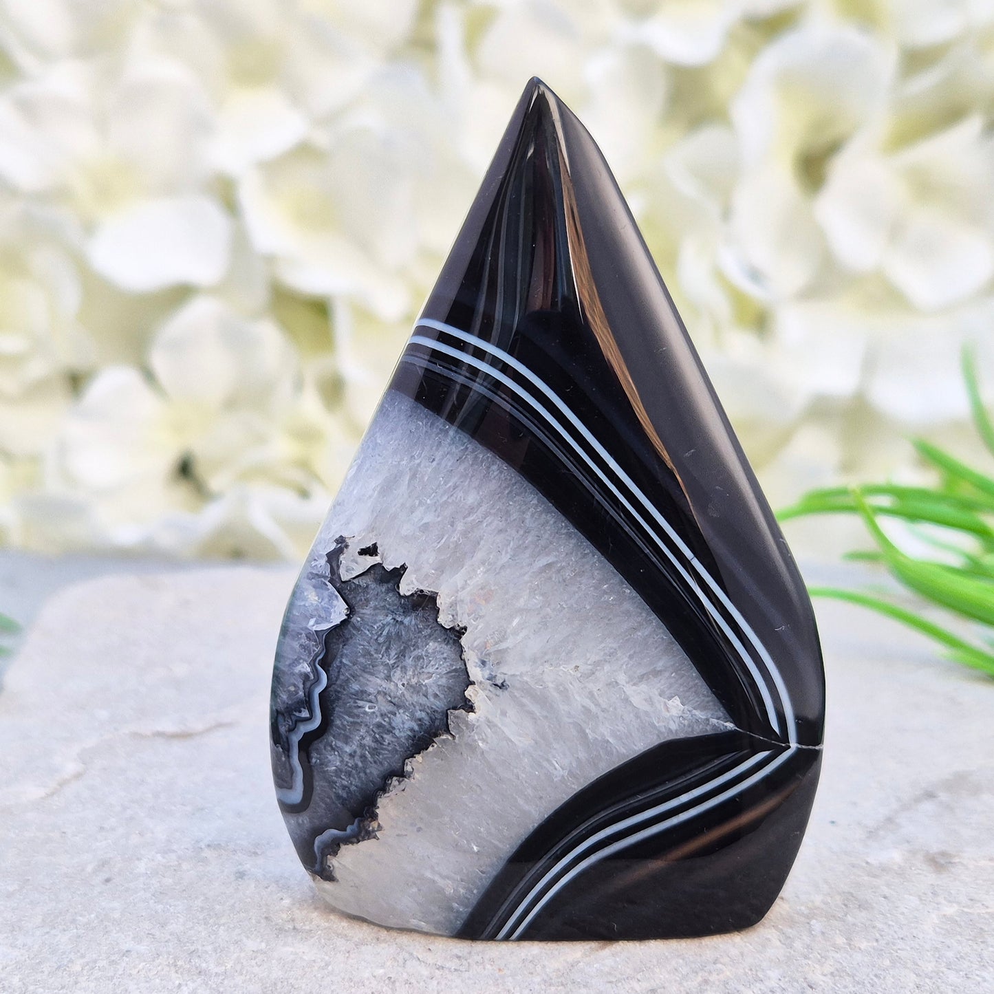 Polished black agate and quartz crystal flame from Brazil, traditionally associated with grounding and balance. A striking natural stone.