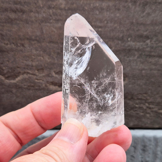 Natural Serra Quartz point from Brazil with clear, high-energy formation. Ideal for amplification, intention work, and focused spiritual practice.