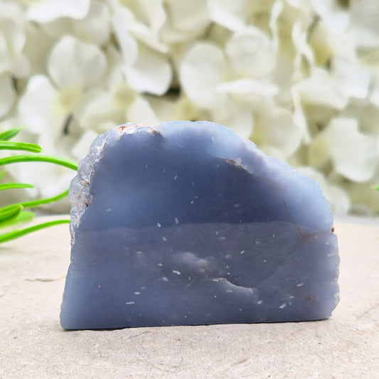 Natural Angelite polished standing freeform from Peru with soft blue tones and raw natural backing. A calming crystal for peaceful spaces.