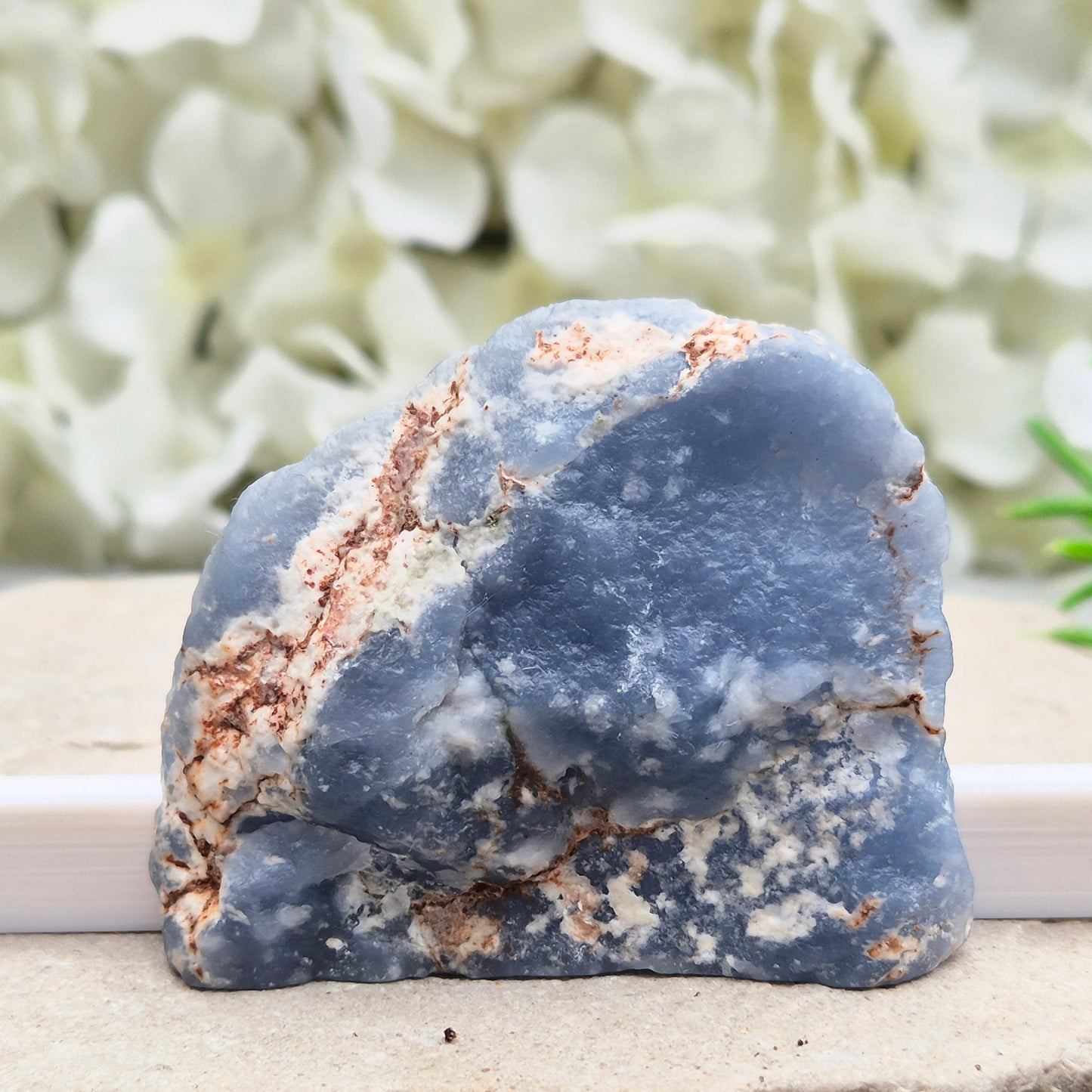 Natural Angelite polished standing freeform from Peru with soft blue tones and raw natural backing. A calming crystal for peaceful spaces.