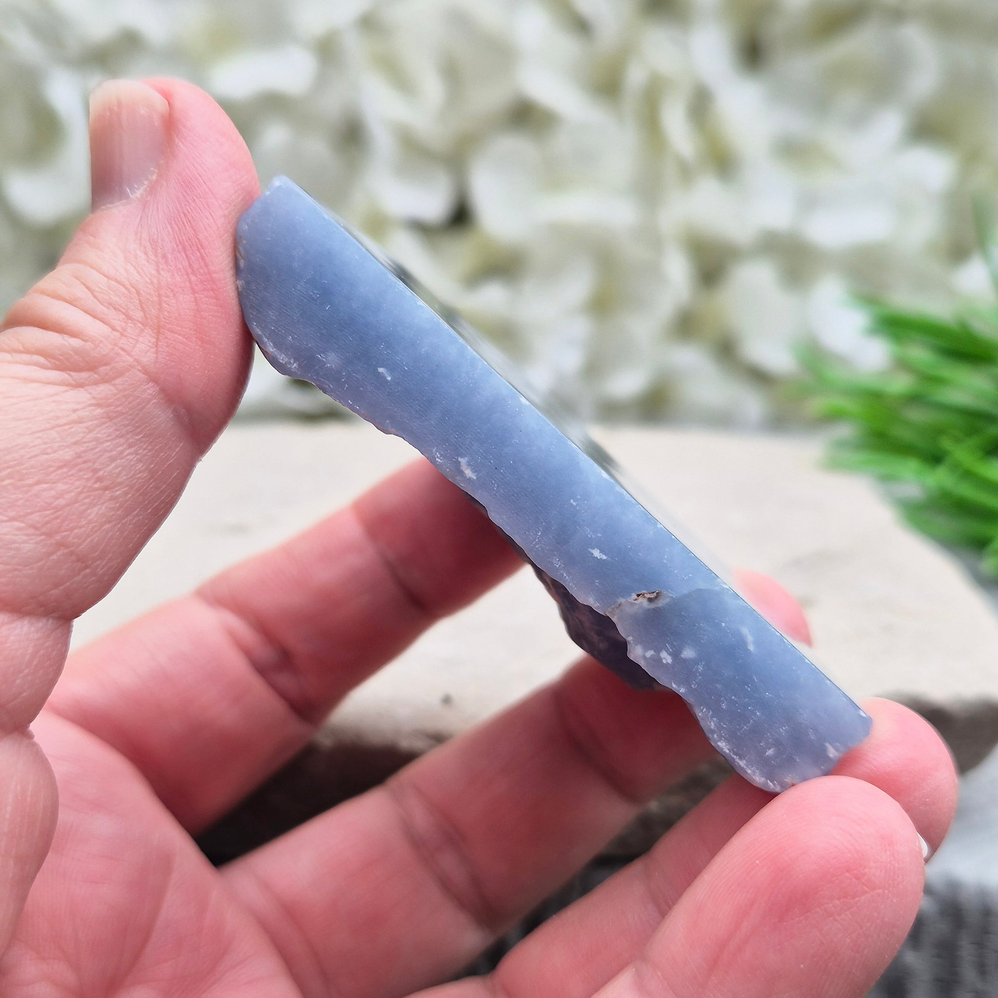 Natural Angelite polished standing freeform from Peru with soft blue tones and raw natural backing. A calming crystal for peaceful spaces.
