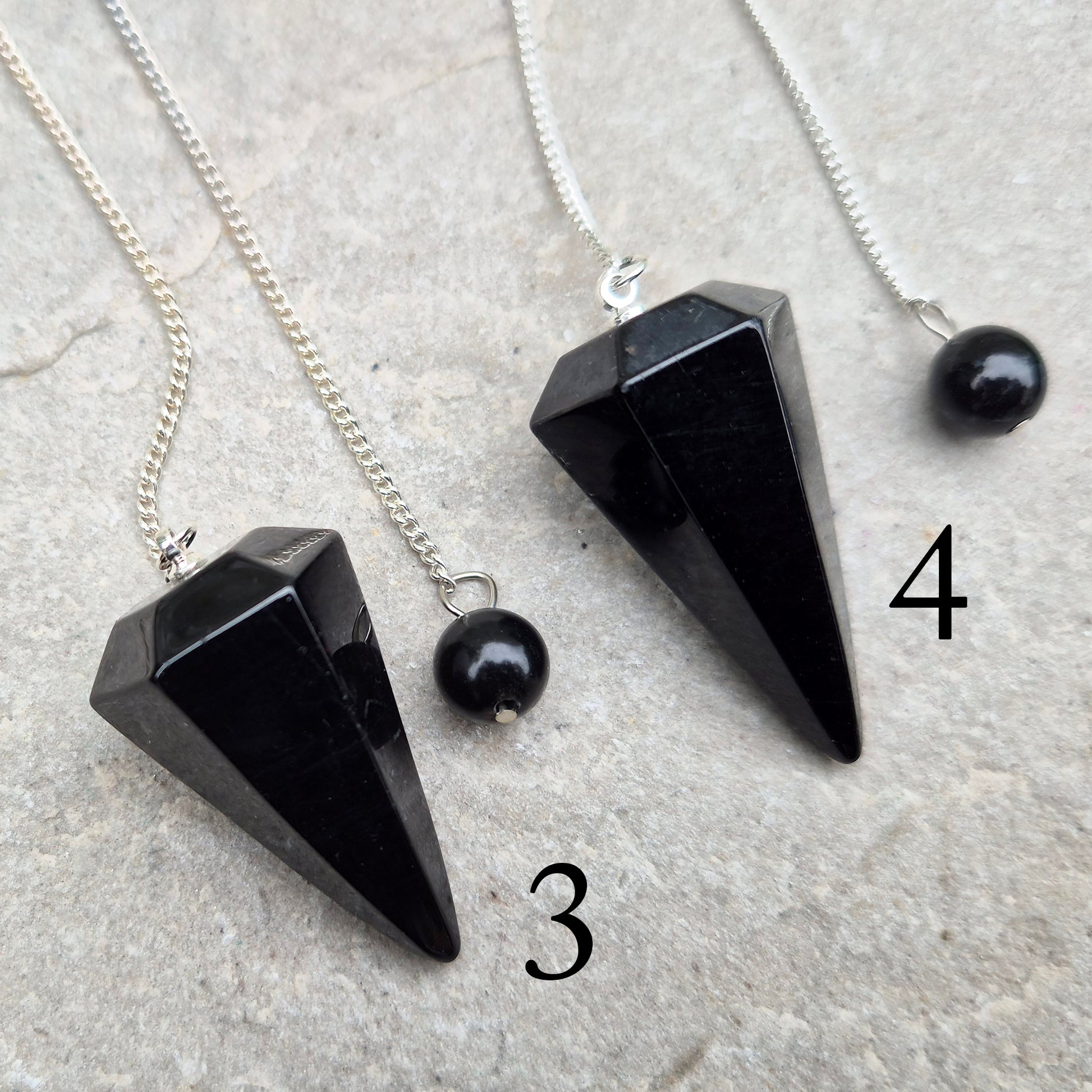 Natural Black Tourmaline crystal pendulum for dowsing, divination, and spiritual work. A grounding stone linked with protection and balance.