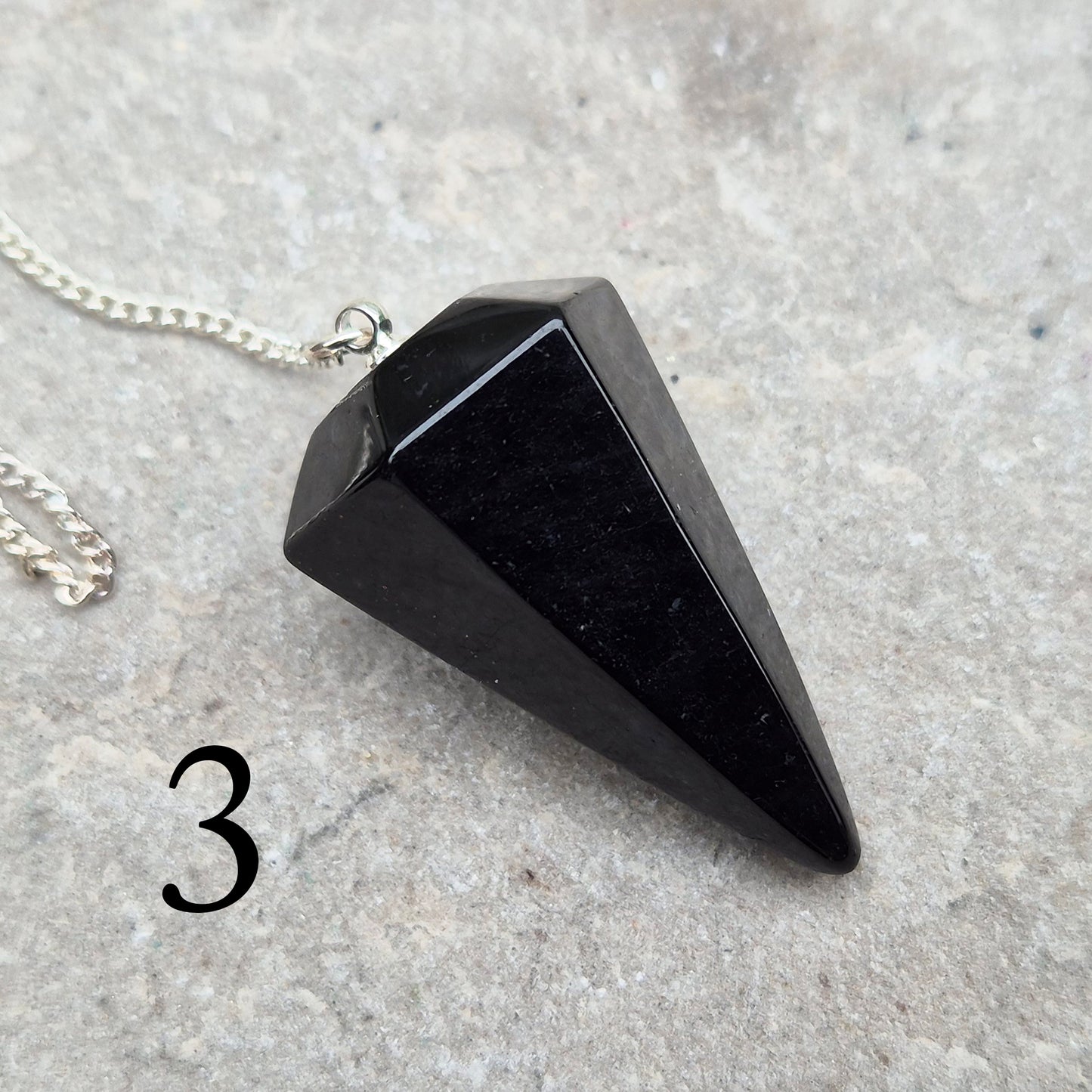 Natural Black Tourmaline crystal pendulum for dowsing, divination, and spiritual work. A grounding stone linked with protection and balance