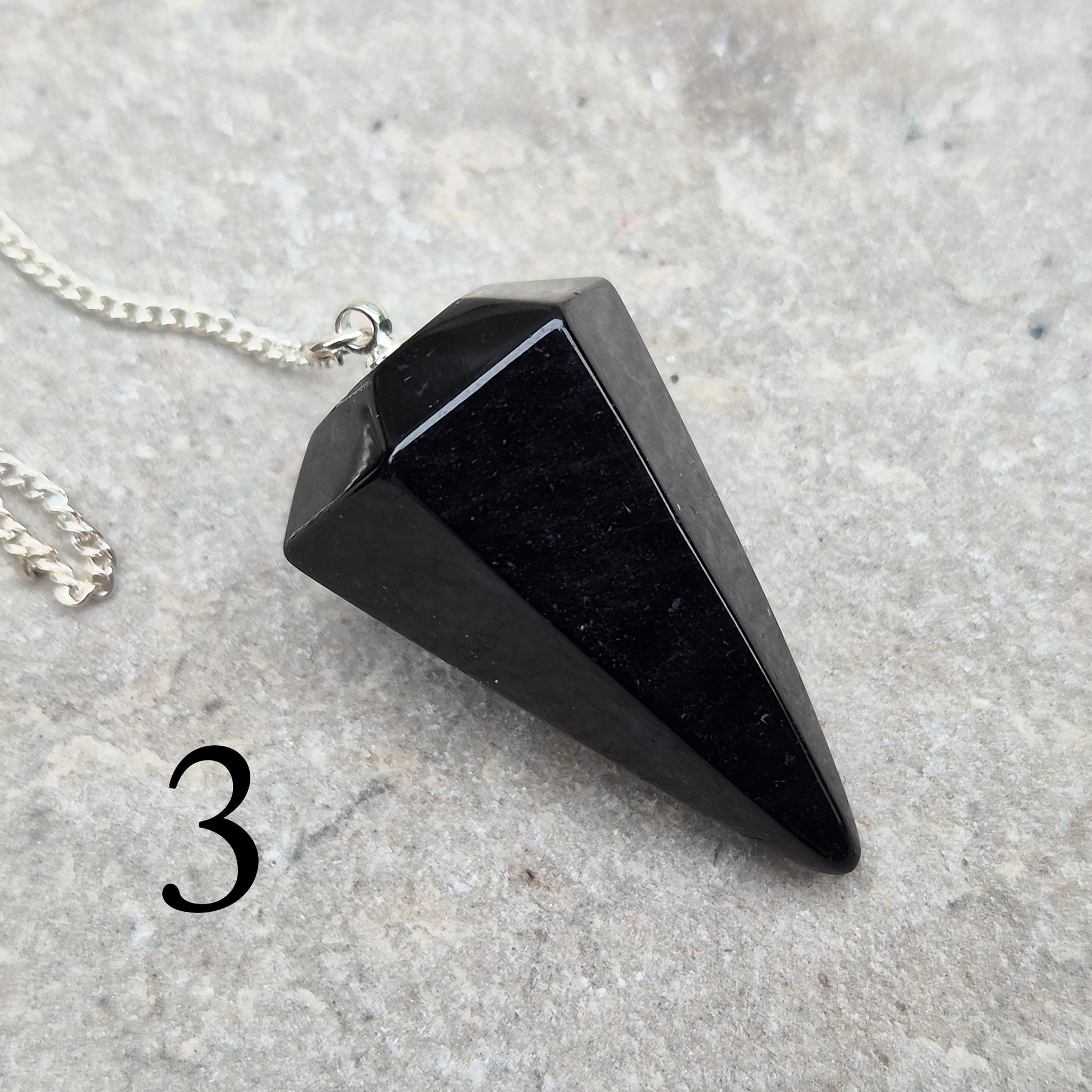 Natural Black Tourmaline crystal pendulum for dowsing, divination, and spiritual work. A grounding stone linked with protection and balance