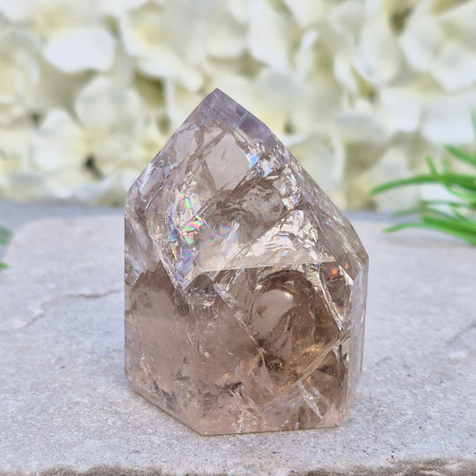 Fire and Ice Smoky Quartz point from Brazil with rainbow flashes and grounding energy. A striking crystal for balance, reflection, and change.