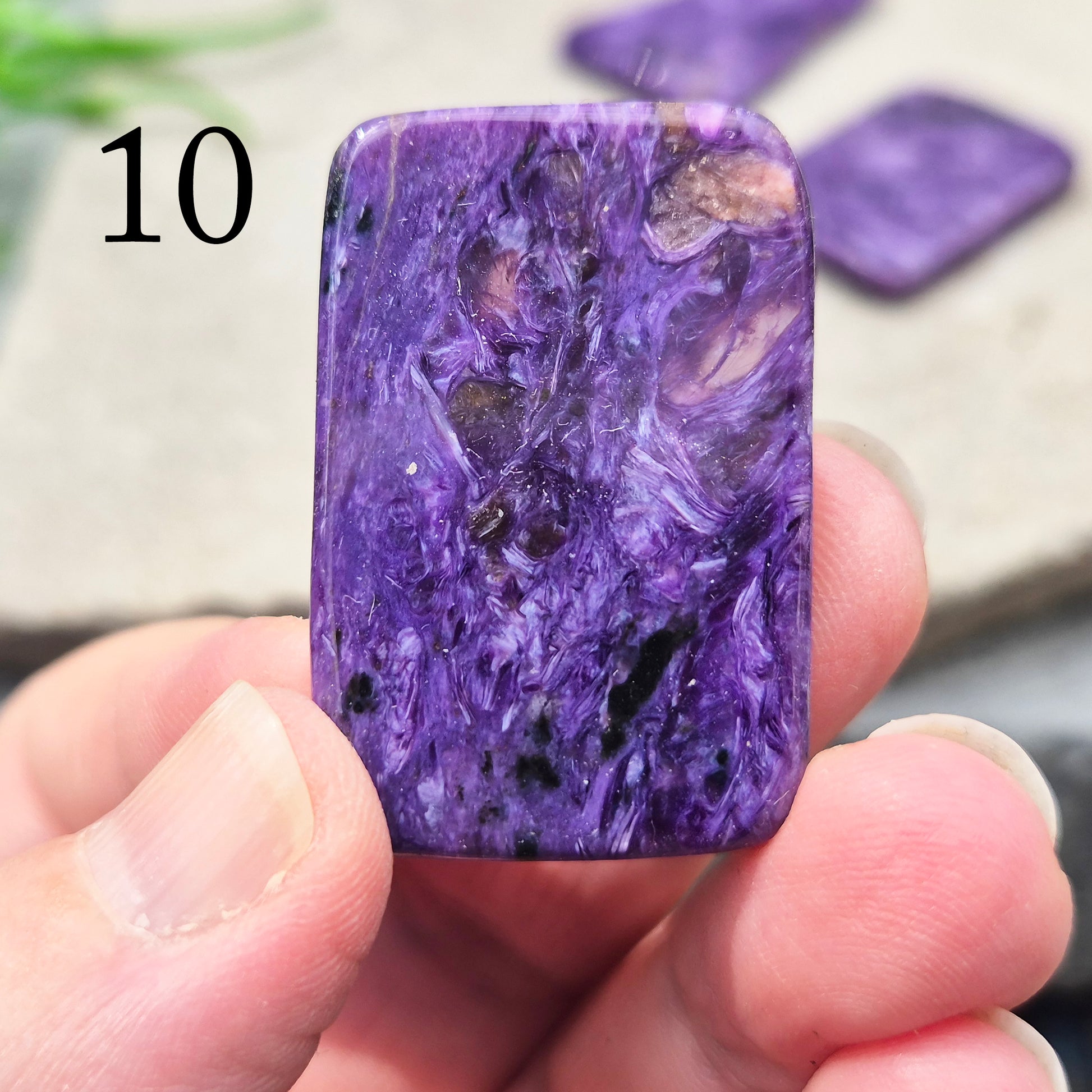 Polished Charoite slice with rich purple swirling patterns. A striking crystal associated with transformation, emotional strength, and personal growth.