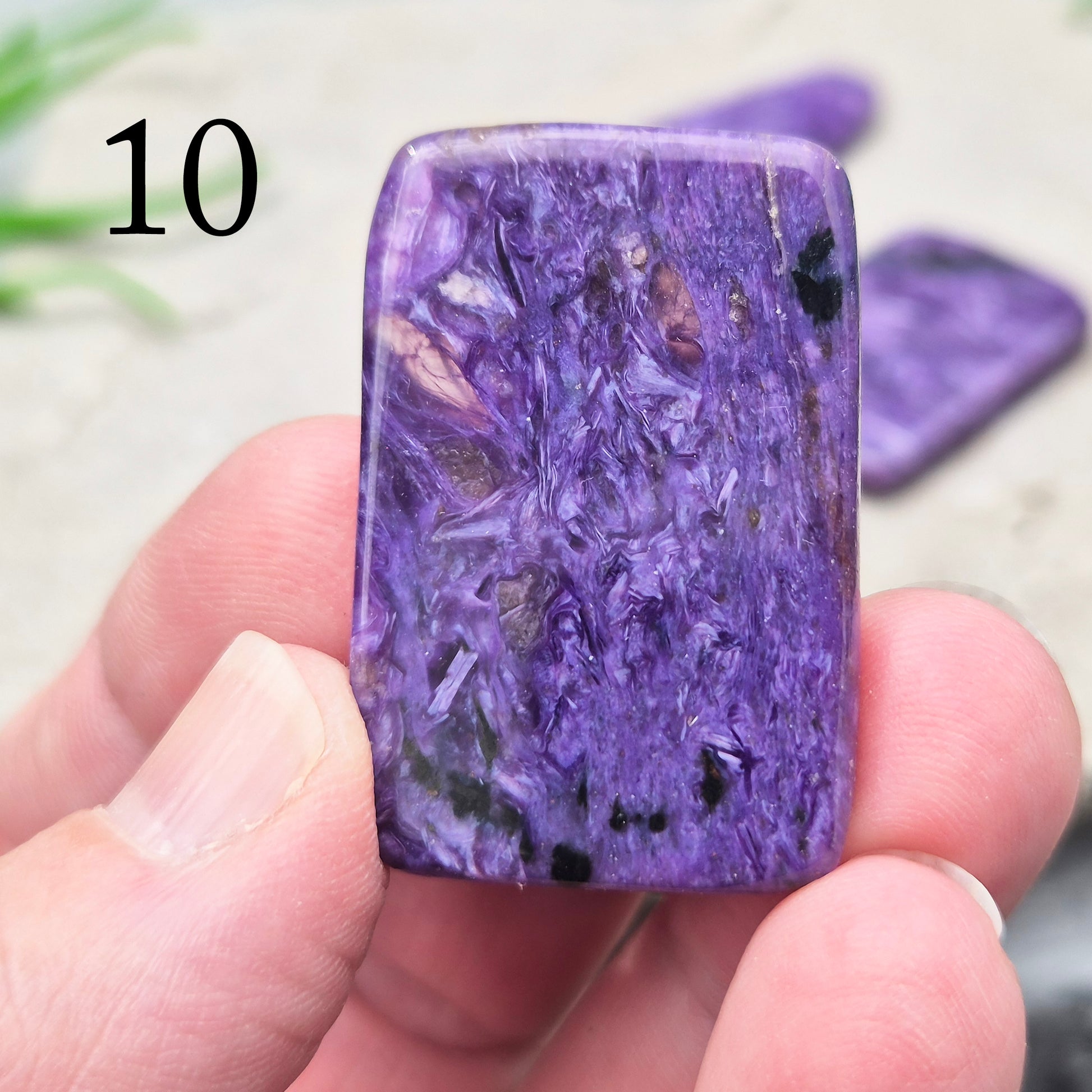 Polished Charoite slice with rich purple swirling patterns. A striking crystal associated with transformation, emotional strength, and personal growth.