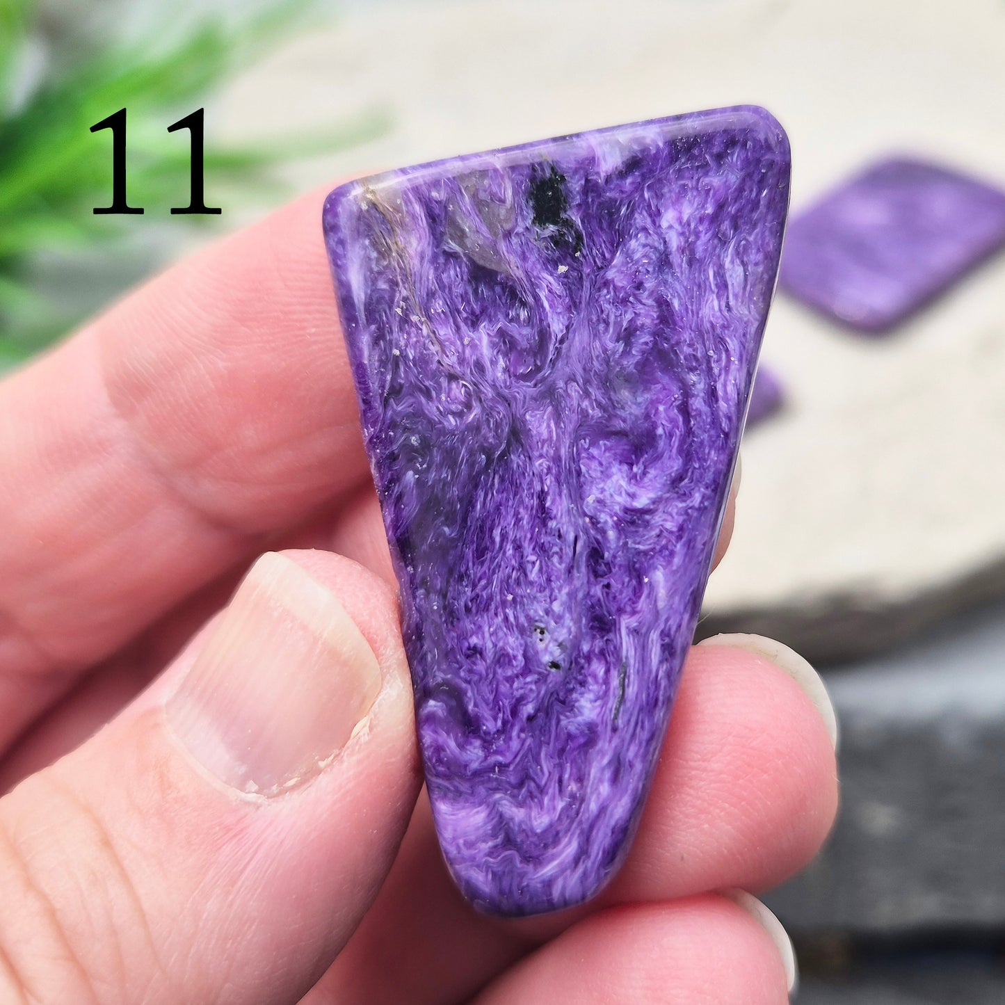 Polished Charoite slice with rich purple swirling patterns. A striking crystal associated with transformation, emotional strength, and personal growth.