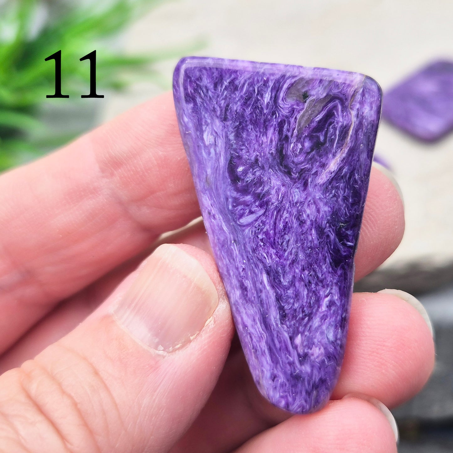 Polished Charoite slice with rich purple swirling patterns. A striking crystal associated with transformation, emotional strength, and personal growth.
