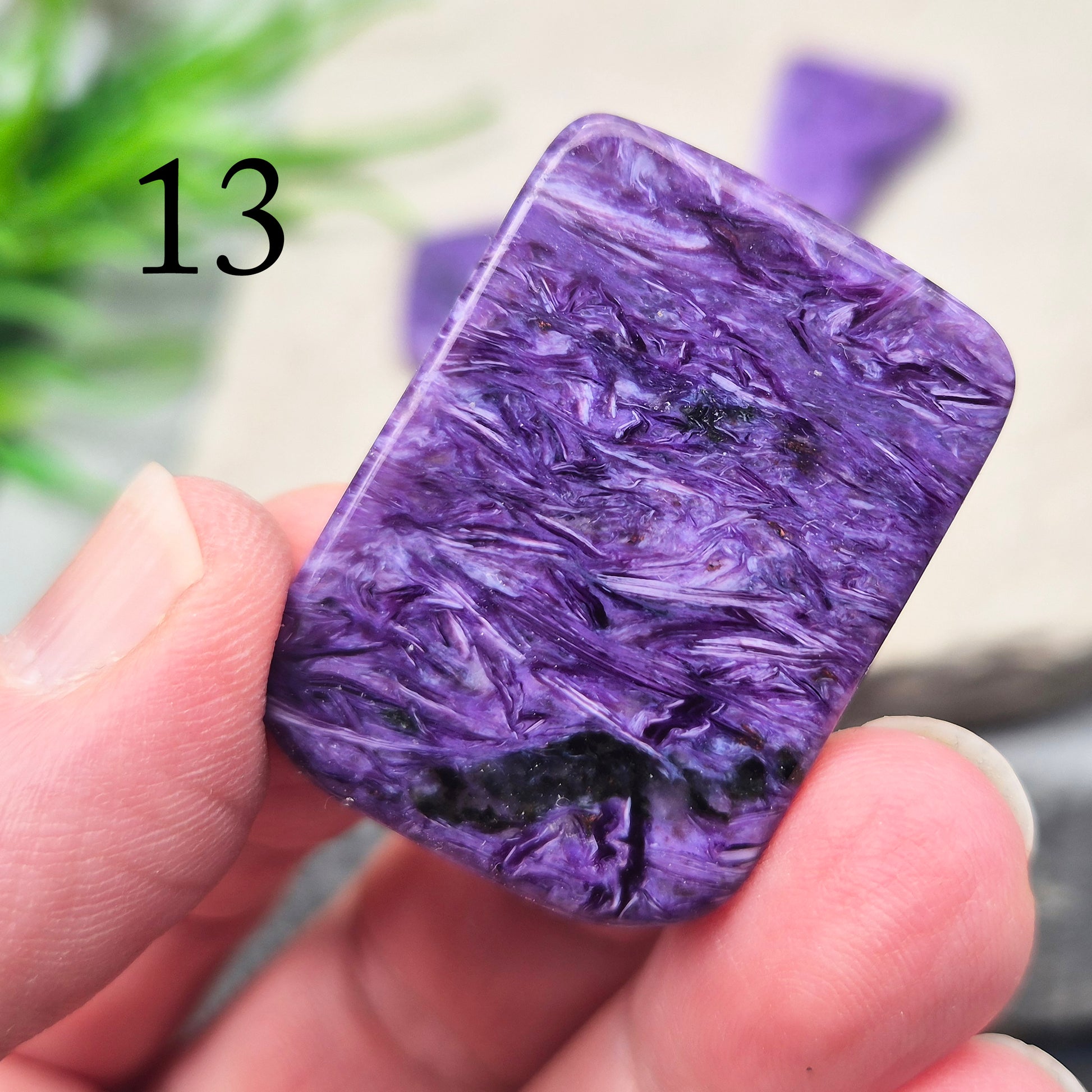 Polished Charoite slice with rich purple swirling patterns. A striking crystal associated with transformation, emotional strength, and personal growth.