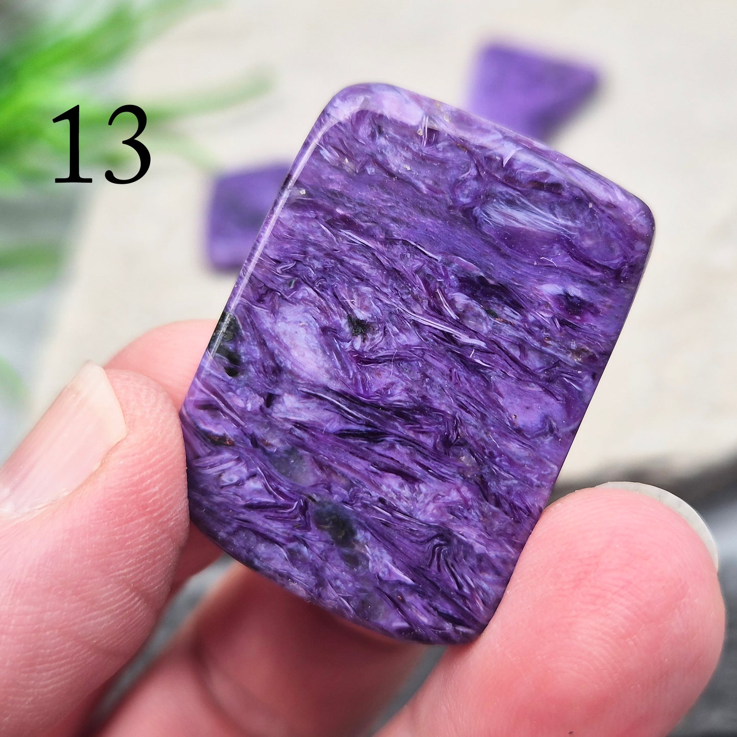 Polished Charoite slice with rich purple swirling patterns. A striking crystal associated with transformation, emotional strength, and personal growth.