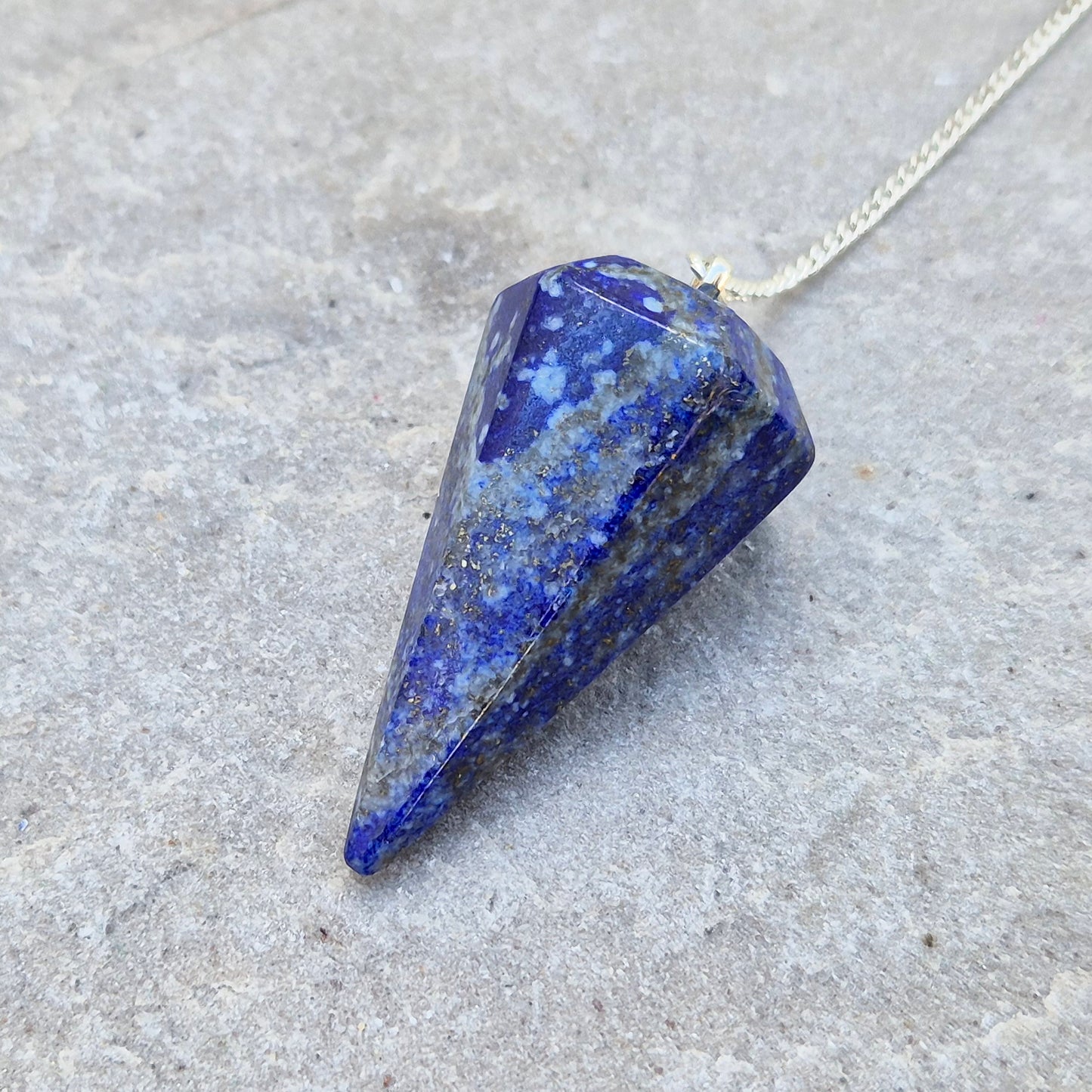 lapis lazuli pendulum for dowsing and intuitive work. A striking blue crystal used for guidance, insight, and energy balancing practices.
