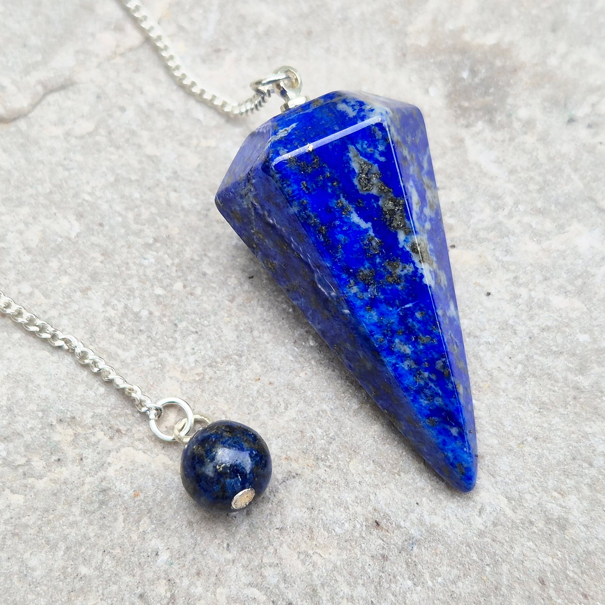 Lapis lazuli pendulum for divination and intuition work. A deep blue crystal pendulum used for guidance, energy reading, and spiritual focus.
