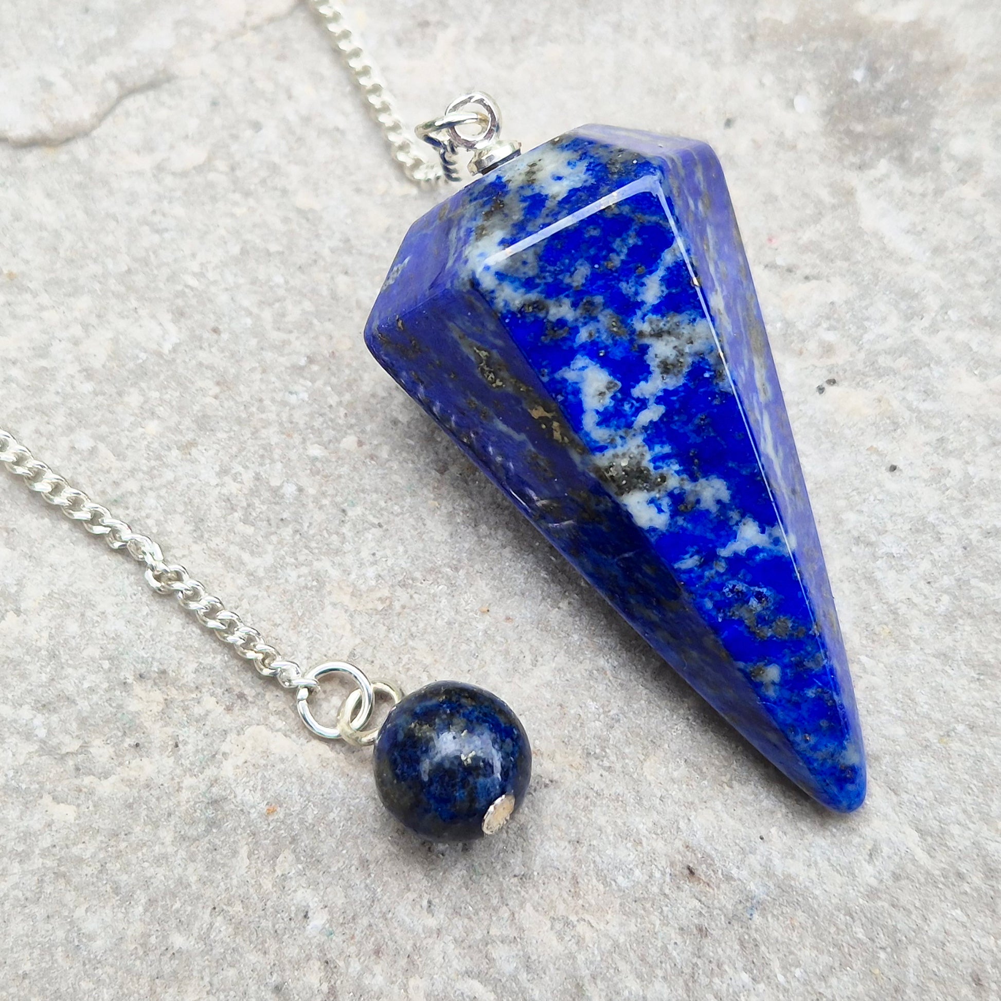 Lapis lazuli pendulum for divination and intuition work. A deep blue crystal pendulum used for guidance, energy reading, and spiritual focus.