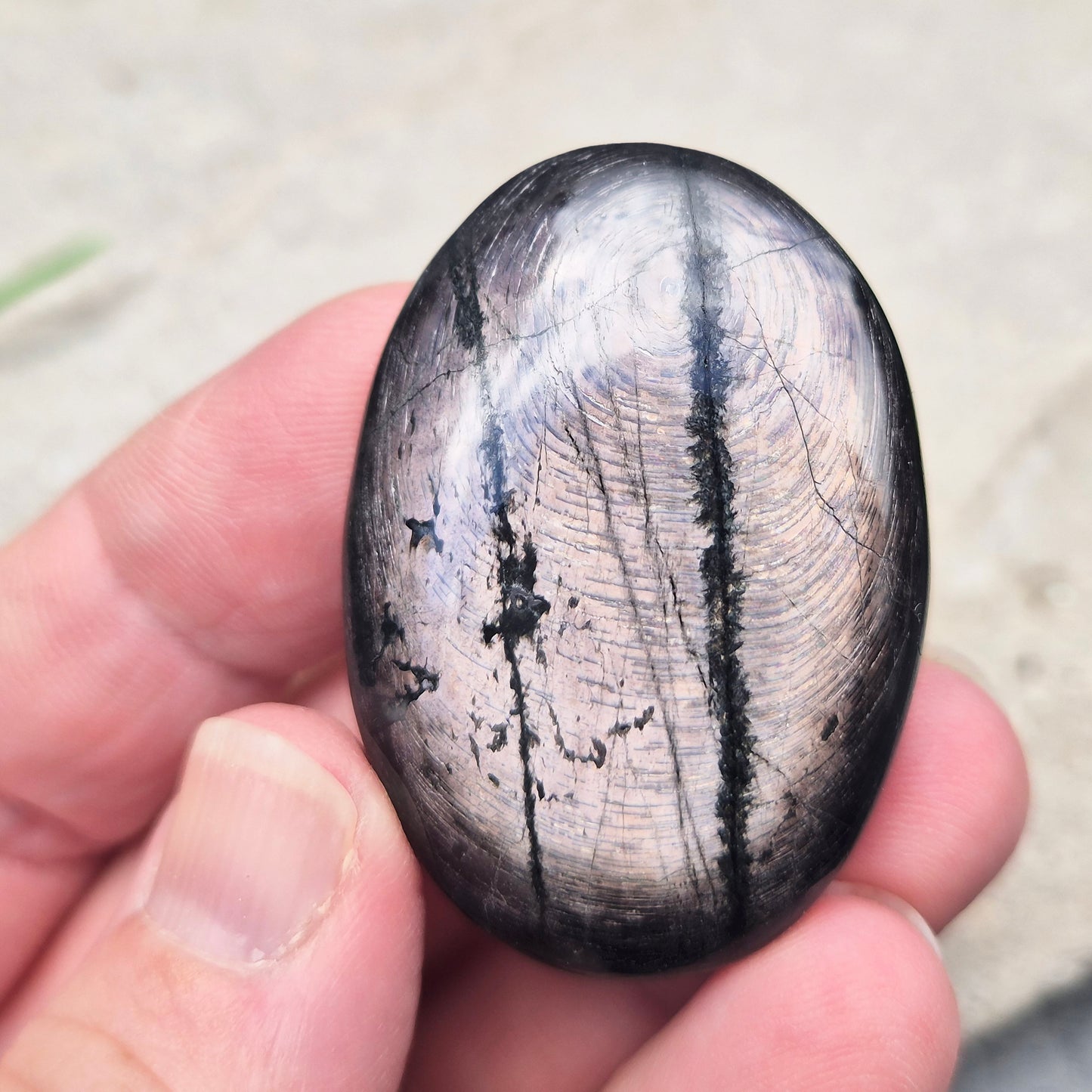 Violet Hypersthene palm stone with a smooth, comforting feel. A grounding crystal often chosen for inner strength, calm focus, and quiet self-reflection.