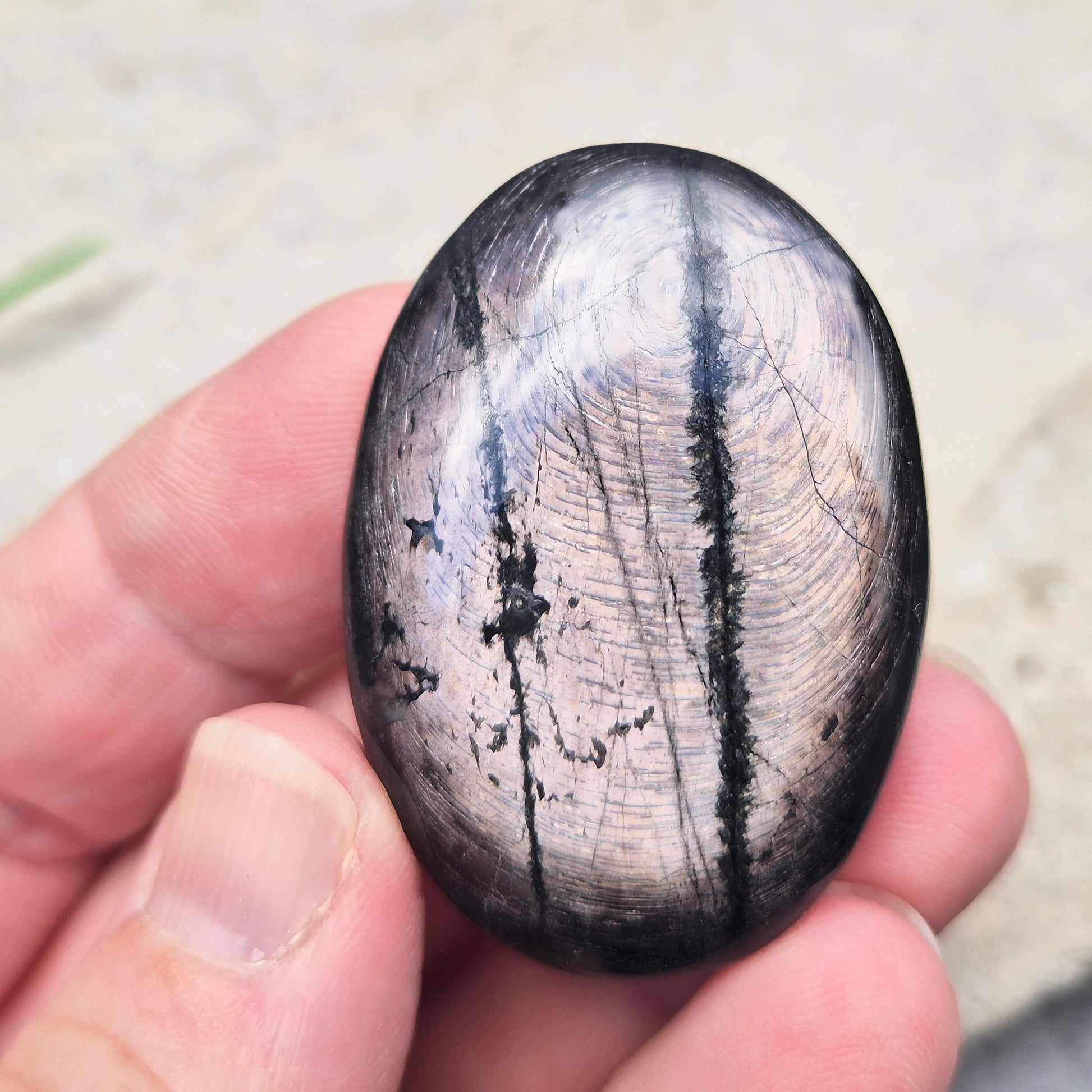 Violet Hypersthene palm stone with a smooth, comforting feel. A grounding crystal often chosen for inner strength, calm focus, and quiet self-reflection.