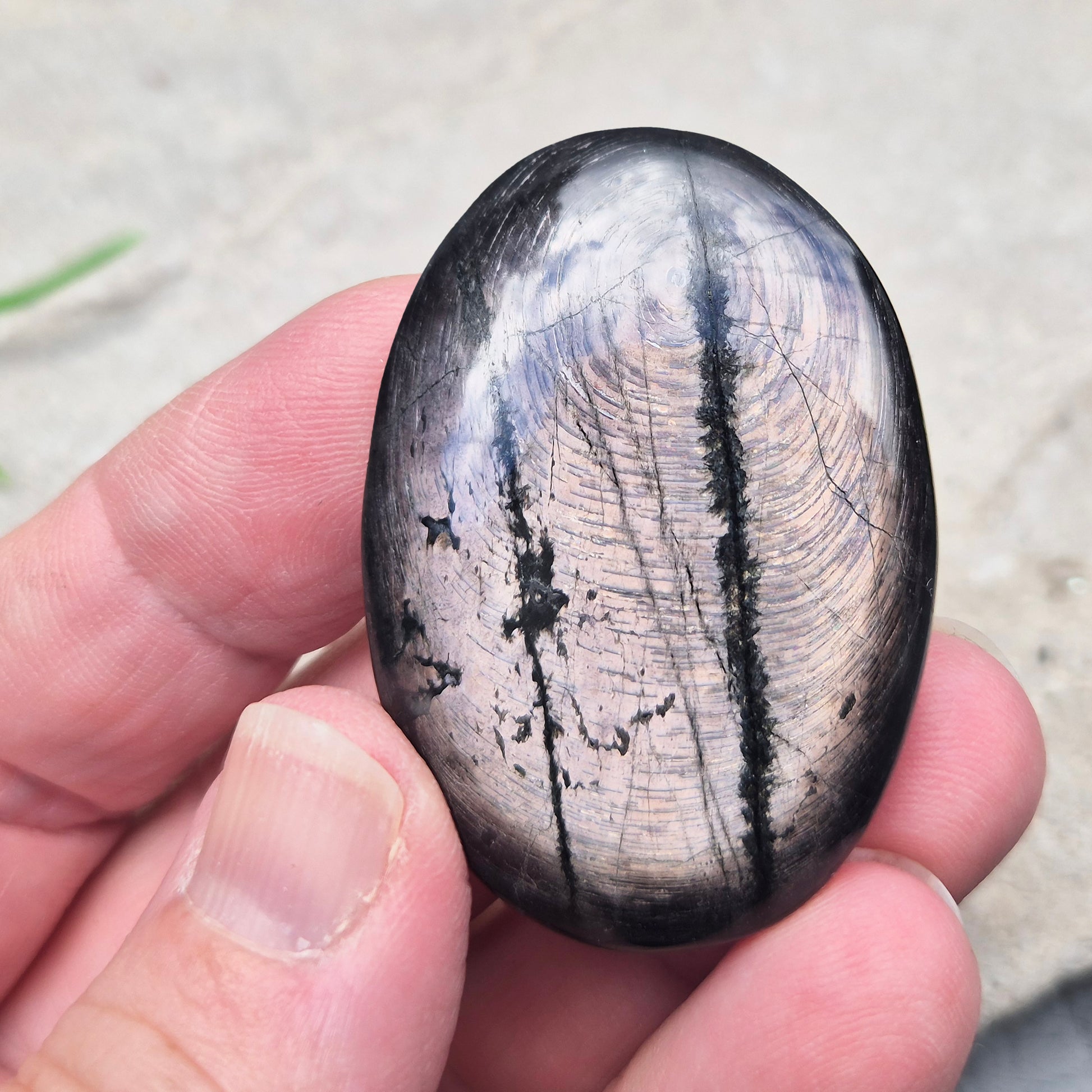 Violet Hypersthene palm stone with a smooth, comforting feel. A grounding crystal often chosen for inner strength, calm focus, and quiet self-reflection.