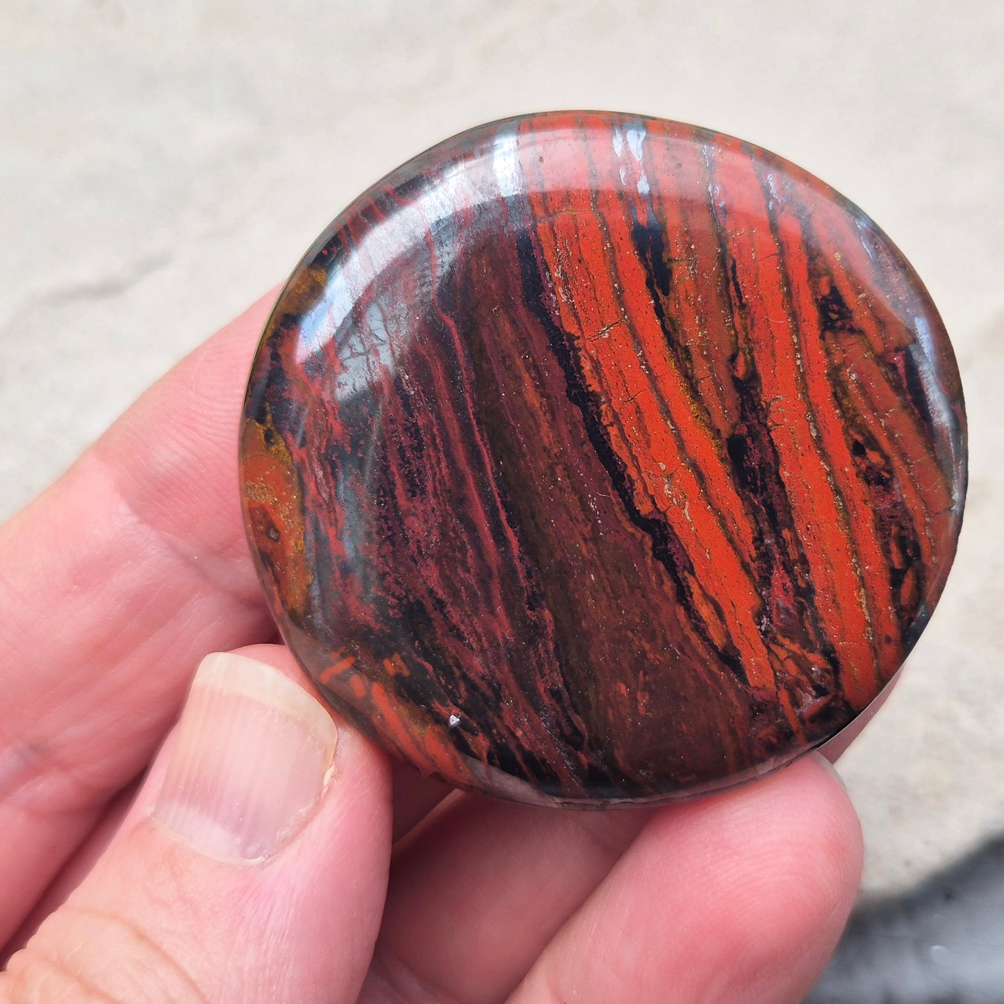 Composite Mugglestone palm stone combining Tiger Eye, Hematite & Red Jasper. Grounding, protective energy supporting focus, strength, and balance.