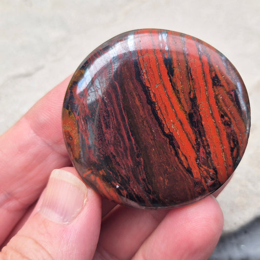 Composite Mugglestone palm stone combining Tiger Eye, Hematite & Red Jasper. Grounding, protective energy supporting focus, strength, and balance.