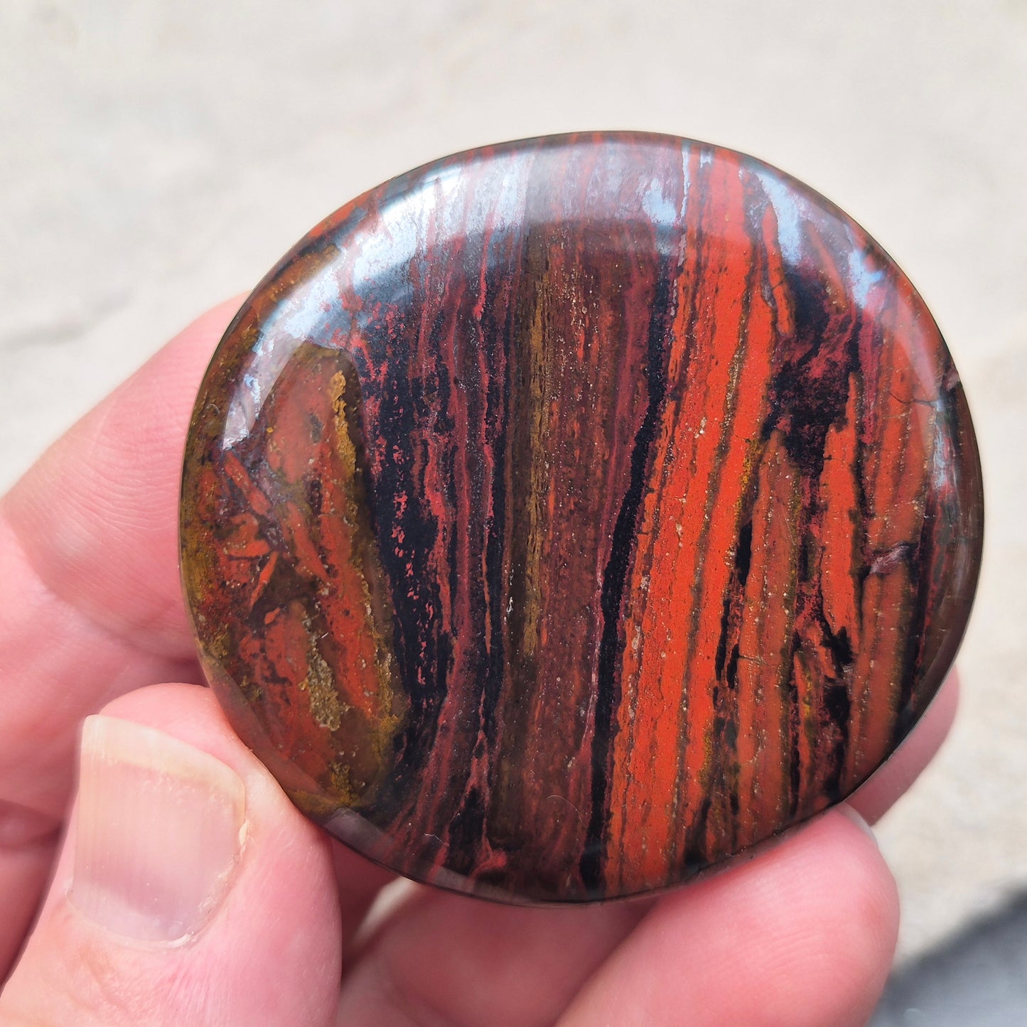 Composite Mugglestone palm stone combining Tiger Eye, Hematite & Red Jasper. Grounding, protective energy supporting focus, strength, and balance.