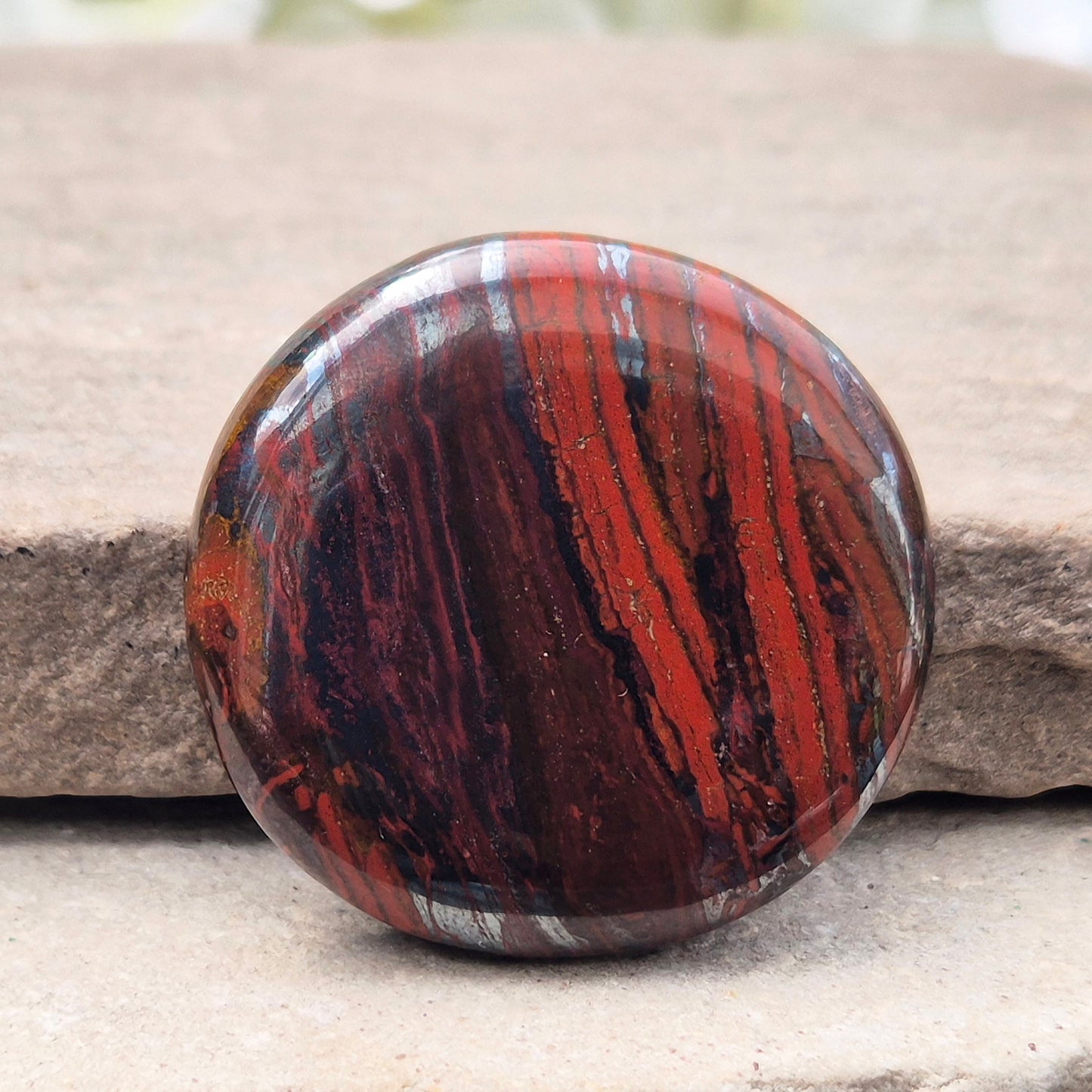 Composite Mugglestone palm stone combining Tiger Eye, Hematite & Red Jasper. Grounding, protective energy supporting focus, strength, and balance.