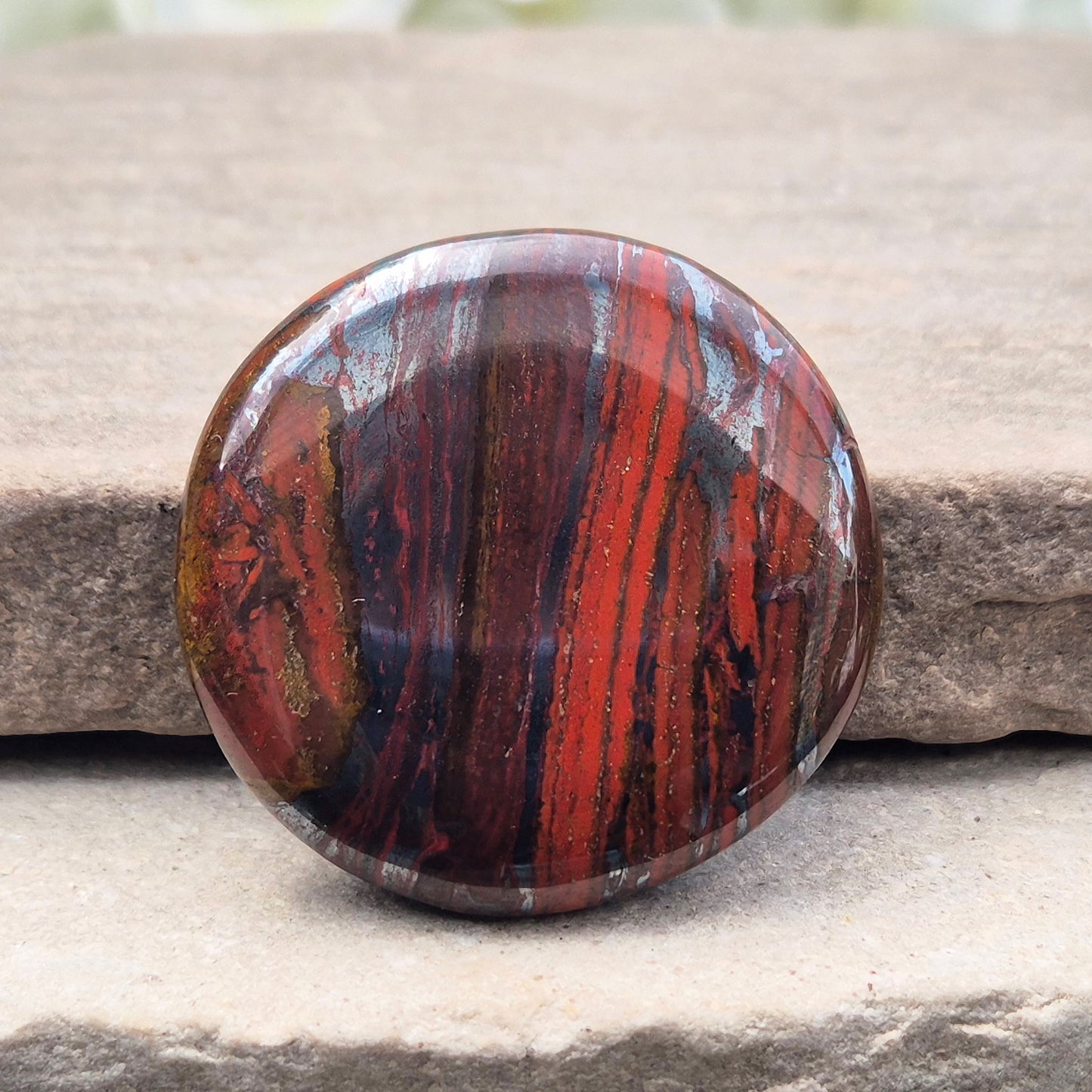 Composite Mugglestone palm stone combining Tiger Eye, Hematite & Red Jasper. Grounding, protective energy supporting focus, strength, and balance.