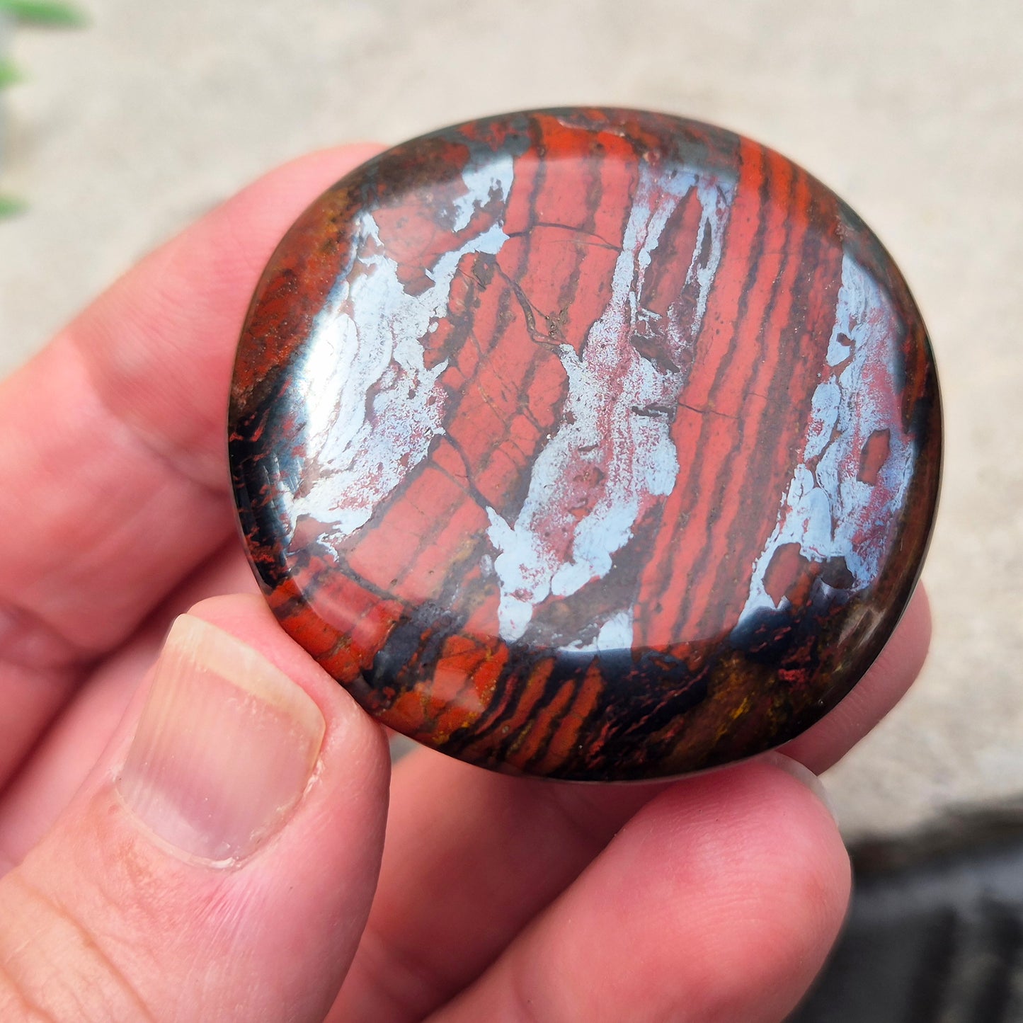 Composite Mugglestone palm stone combining Tiger Eye, Hematite & Red Jasper. Grounding, protective energy supporting focus, strength, and balance.