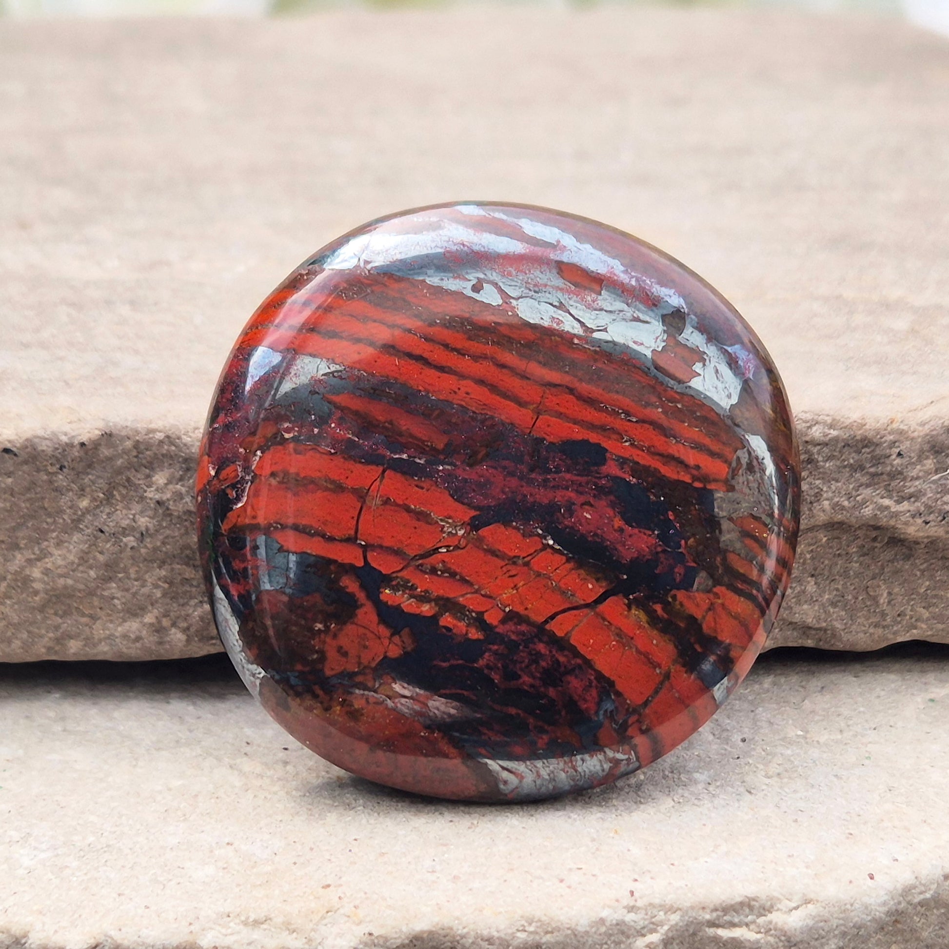 Composite Mugglestone palm stone combining Tiger Eye, Hematite & Red Jasper. Grounding, protective energy supporting focus, strength, and balance.