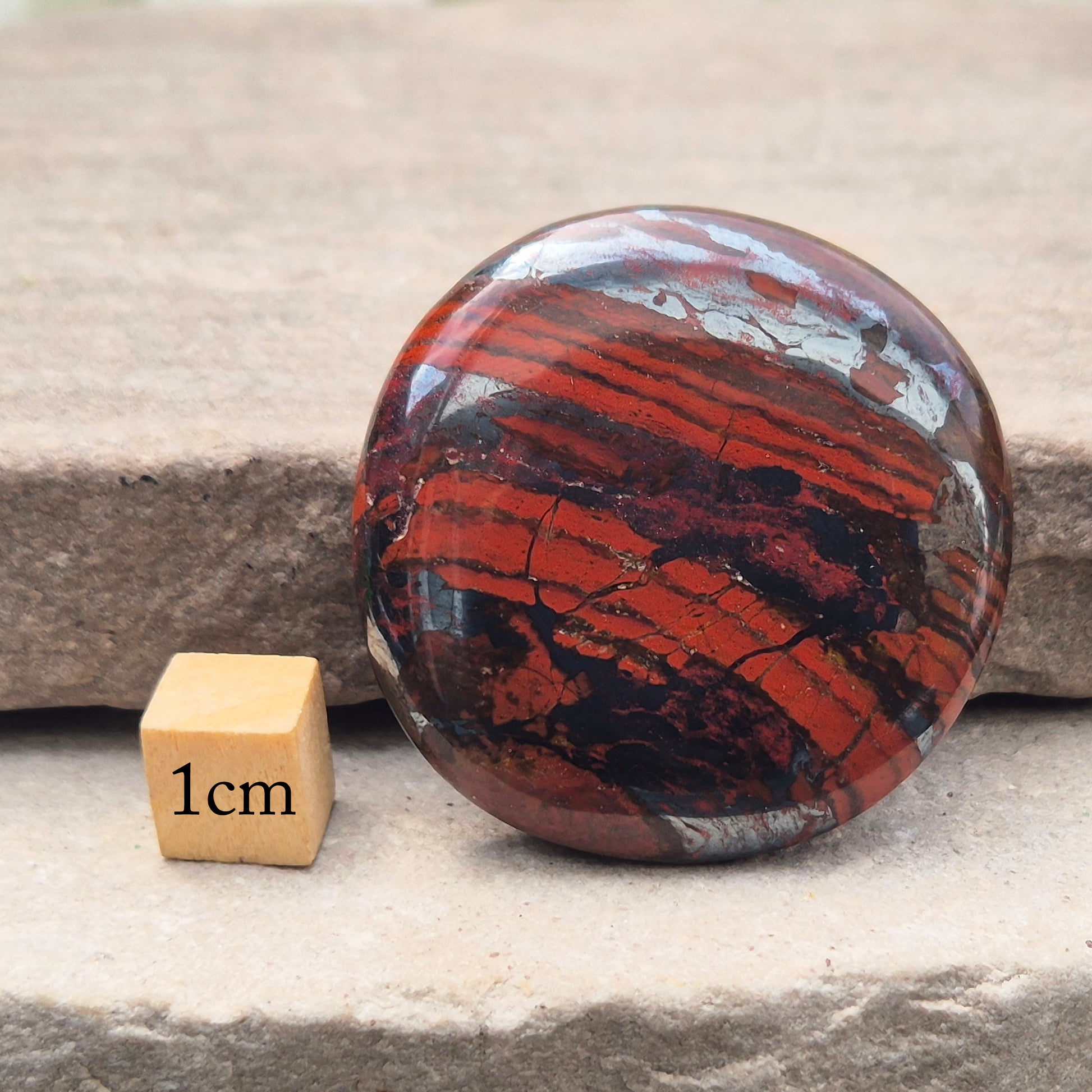 Composite Mugglestone palm stone combining Tiger Eye, Hematite & Red Jasper. Grounding, protective energy supporting focus, strength, and balance.