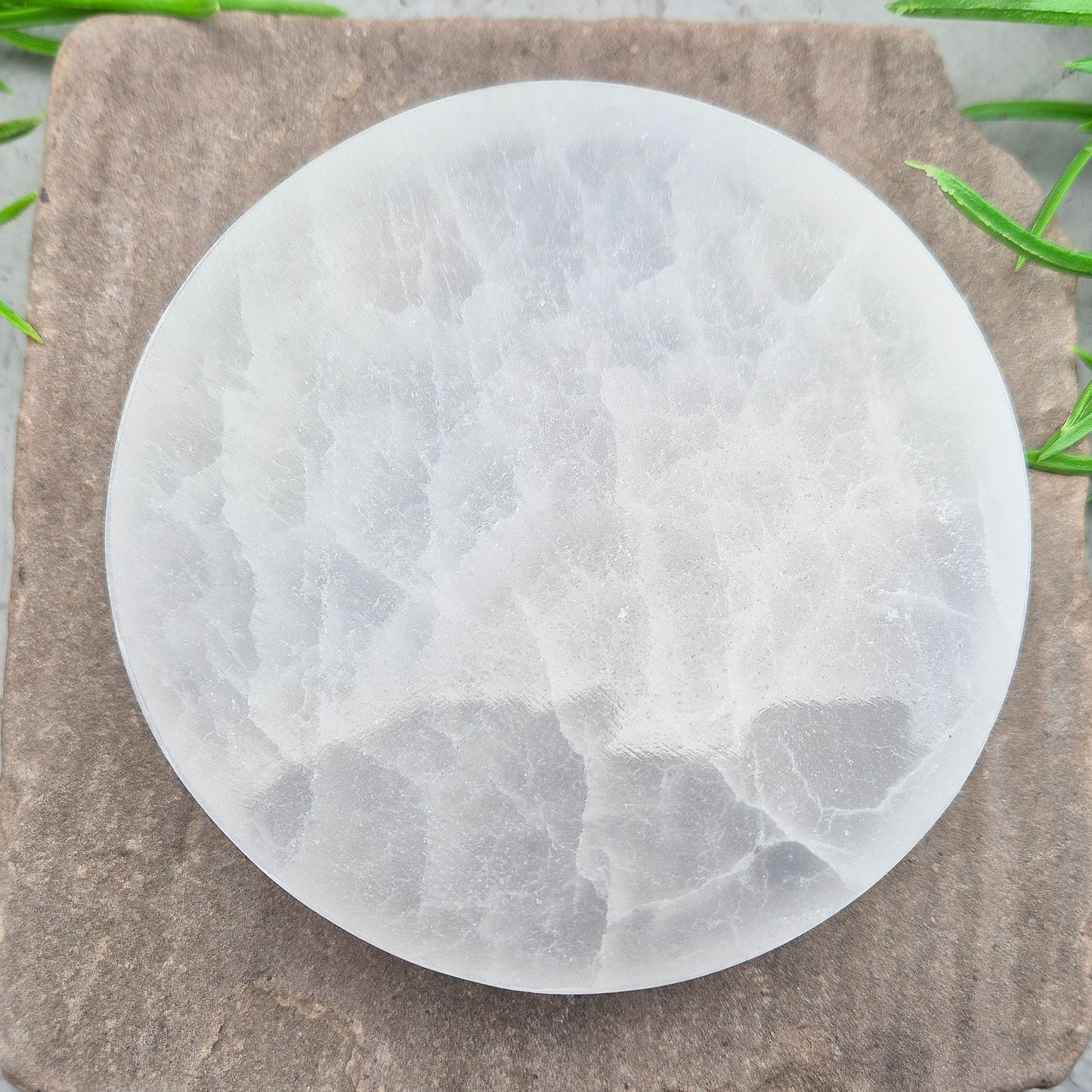 Polished Selenite charging plate that clears heavy energy and recharges your crystals. Ideal for daily cleansing.