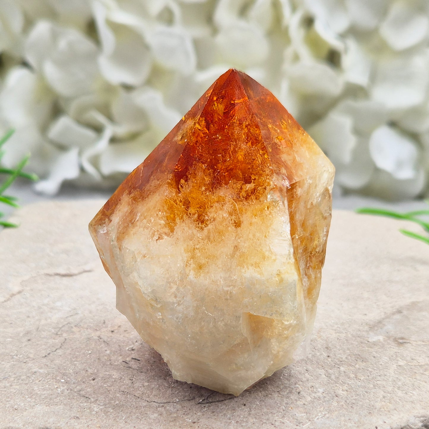 Citrine crystal standing point from Brazil with a polished tip and natural sides. Associated with confidence, motivation, positivity, and personal growth.