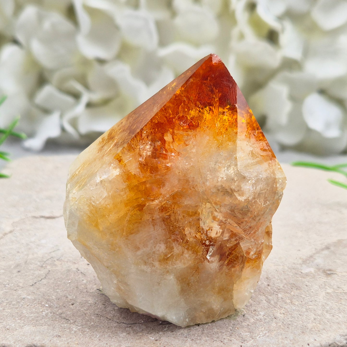 Citrine crystal standing point from Brazil with a polished tip and natural sides. Associated with confidence, motivation, positivity, and personal growth.
